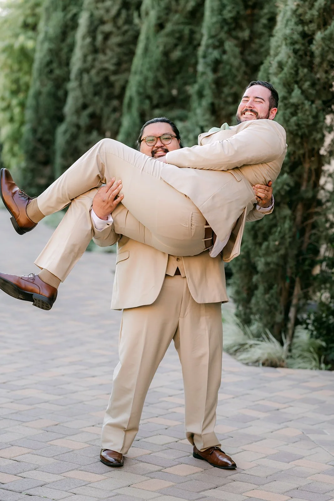 Cody's groomsmen lifting him off his feet.