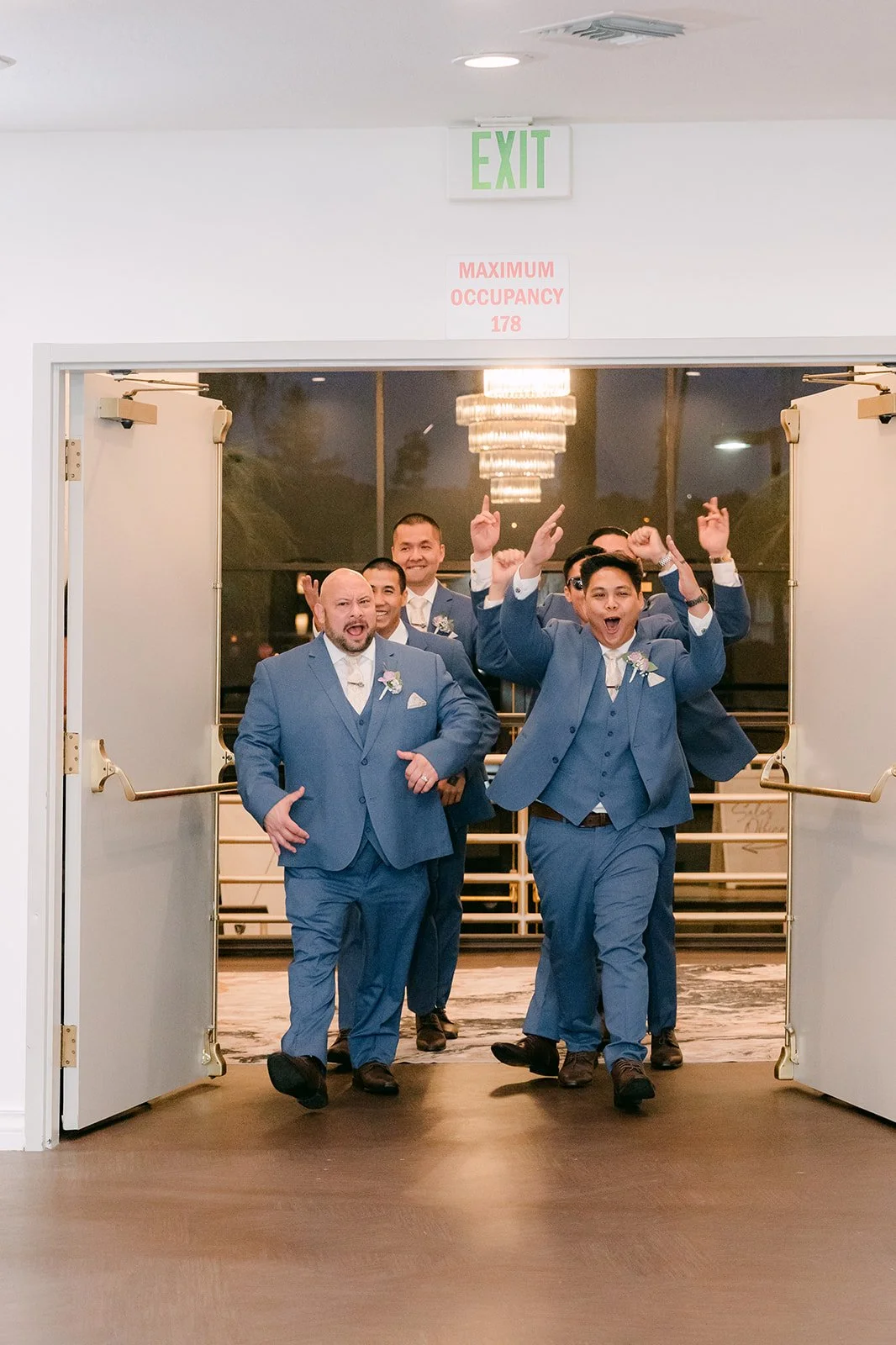 The groomsmen dancing their way into the ballroom.