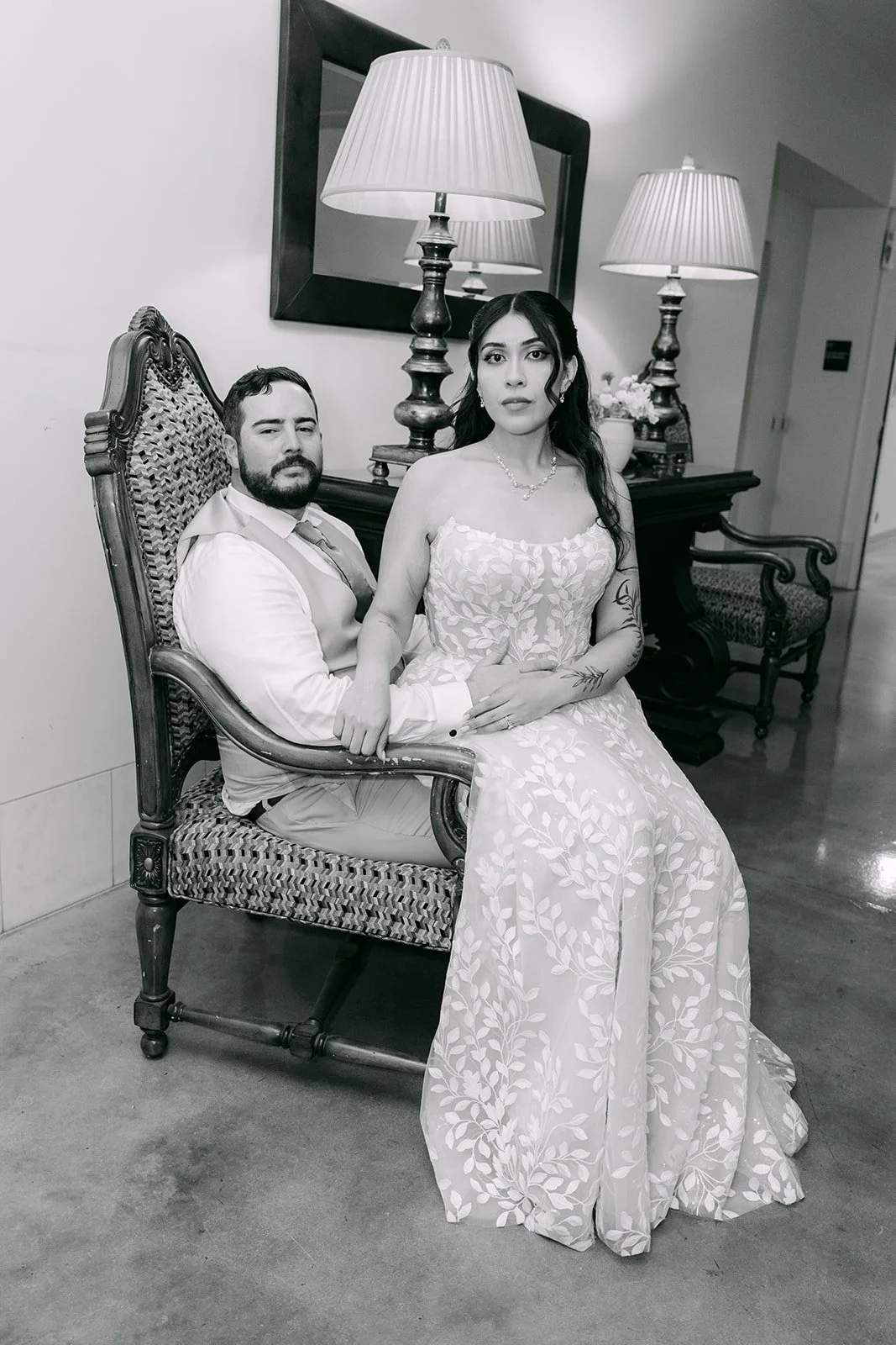 A black and white portrait of Fernanda and Cody seated together, photographed by One and Only Production.