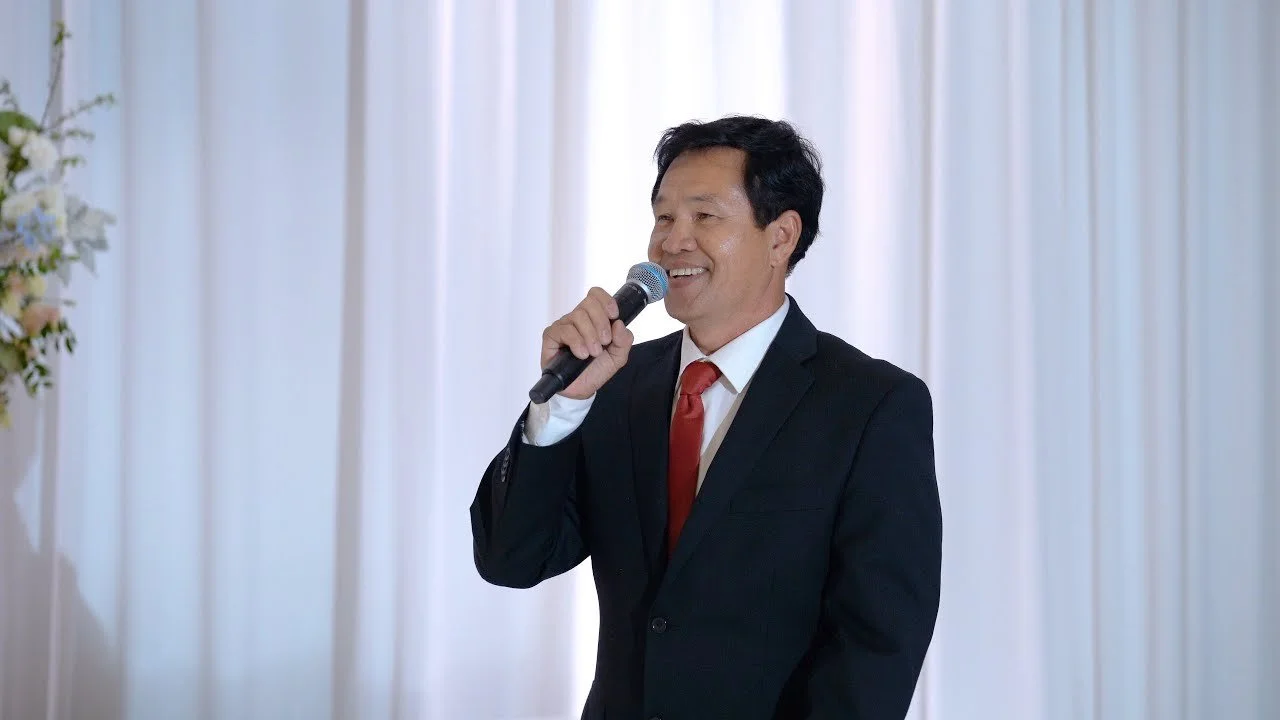 Video still of a parent giving the welcome speech