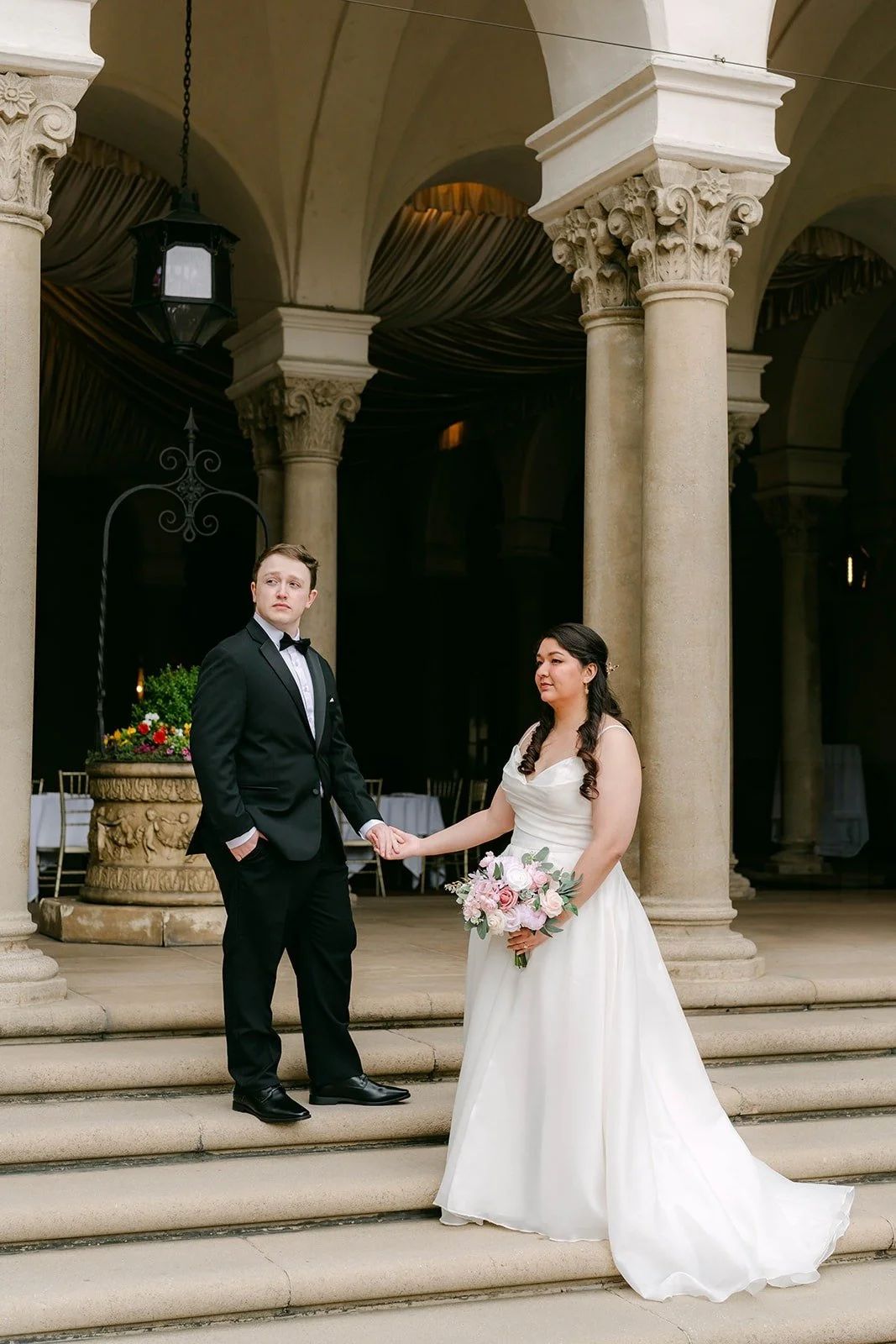 Saira and Matthew on the steps beneath the columns of The Athenaeum