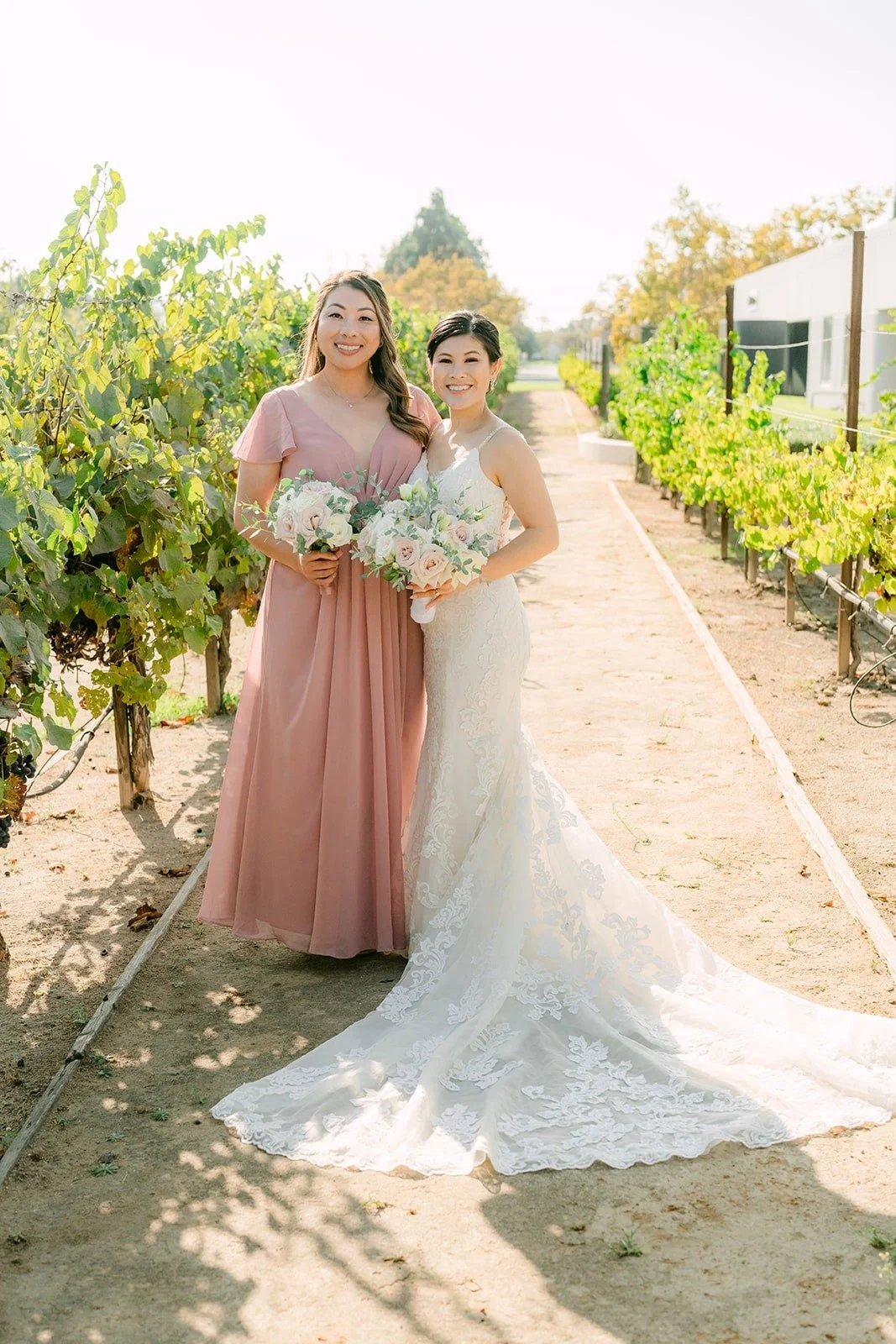 Xuemin hugging a bridesmaid in the vineyard