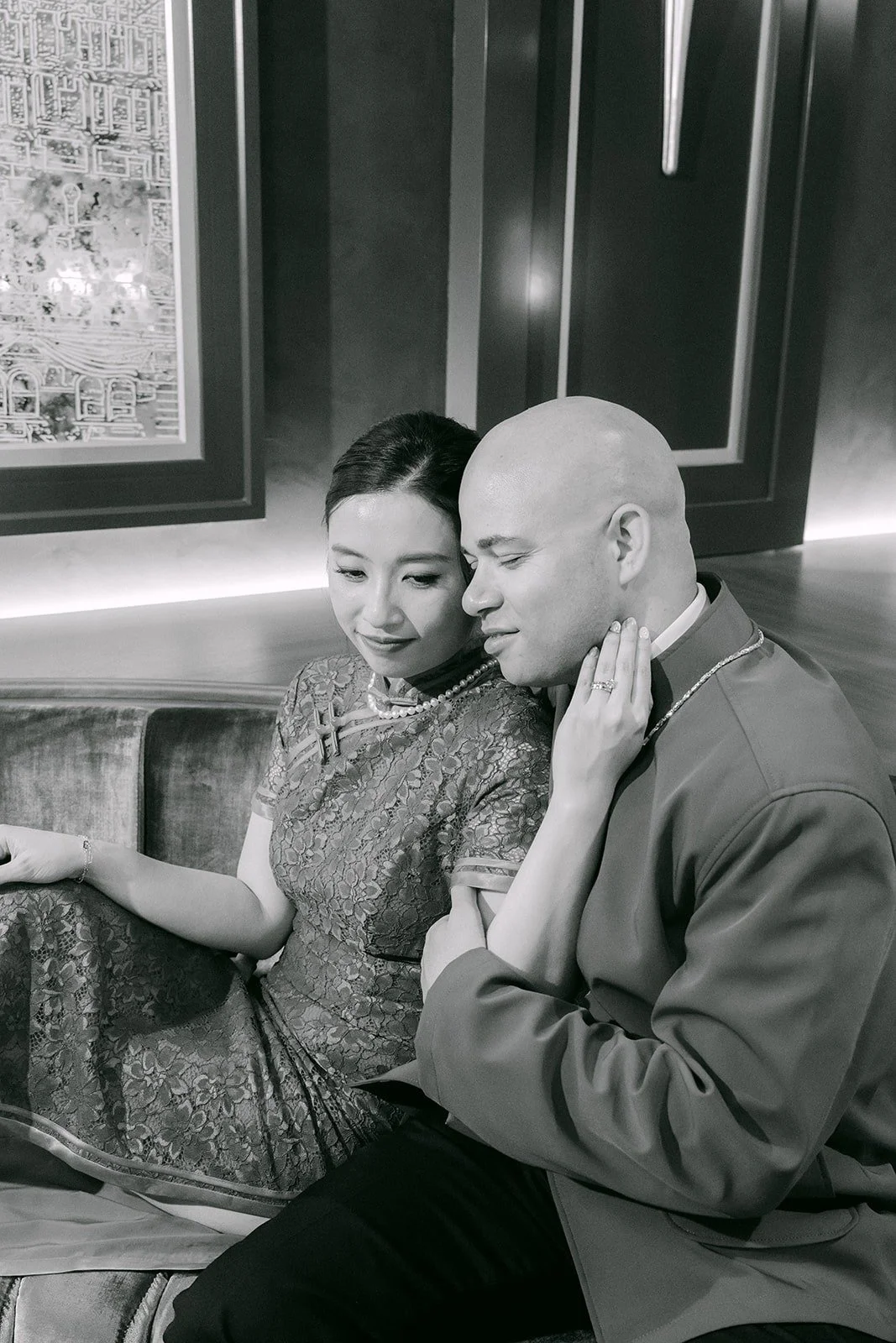 A black and white portrait of Elisa and Brandon sitting close together