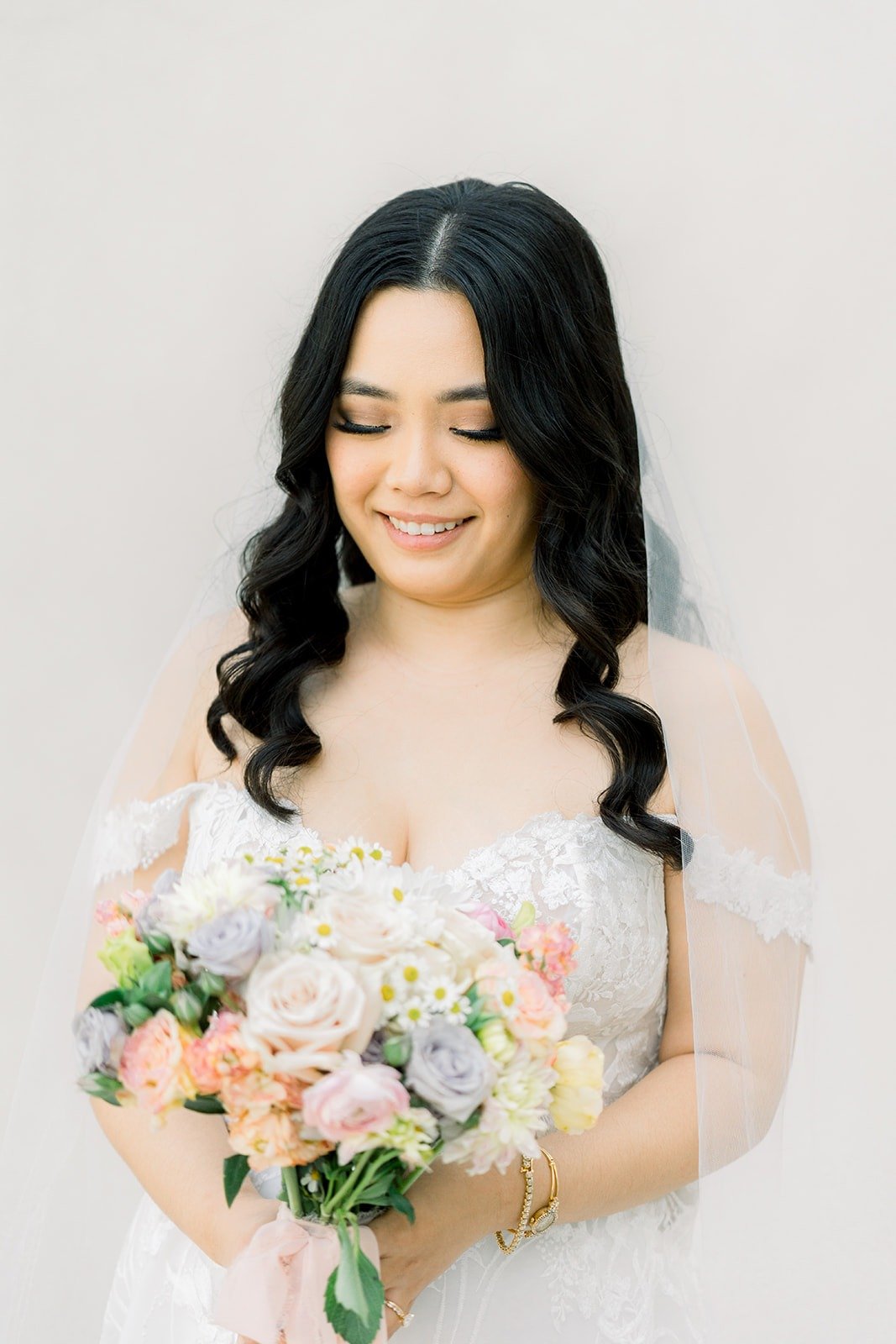Francesca laughing with her veil falling over her shoulder