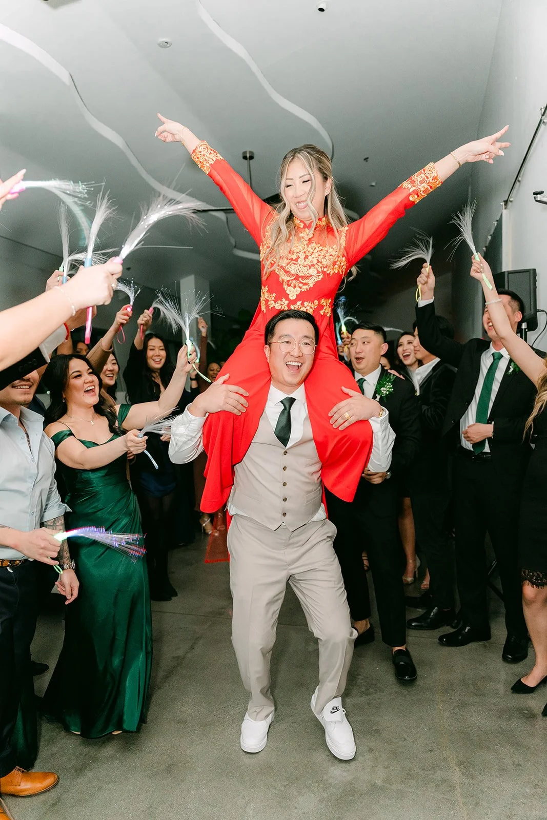 Bride lifted on the groom's shoulders on the dance floor