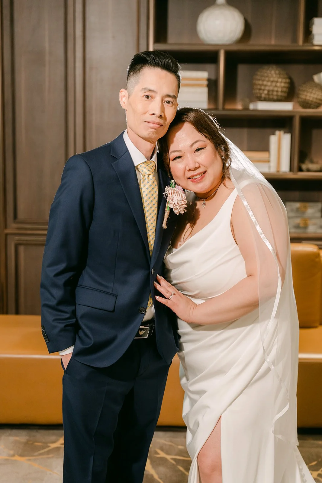 Mai and Bobby in front of the bookshelves, photographed by One and Only Production.