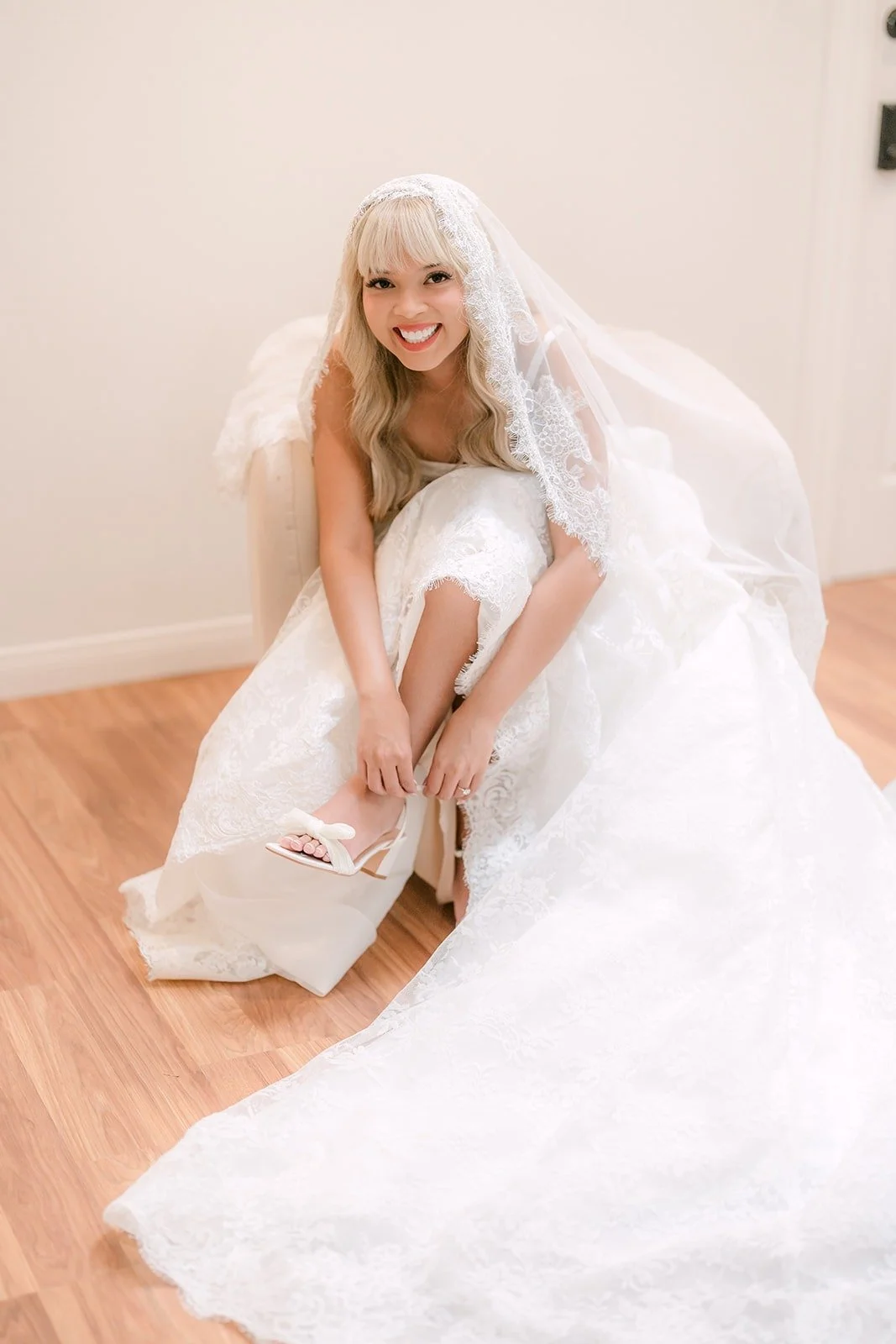 Konitha sitting on the floor in her gown, smiling up at the camera