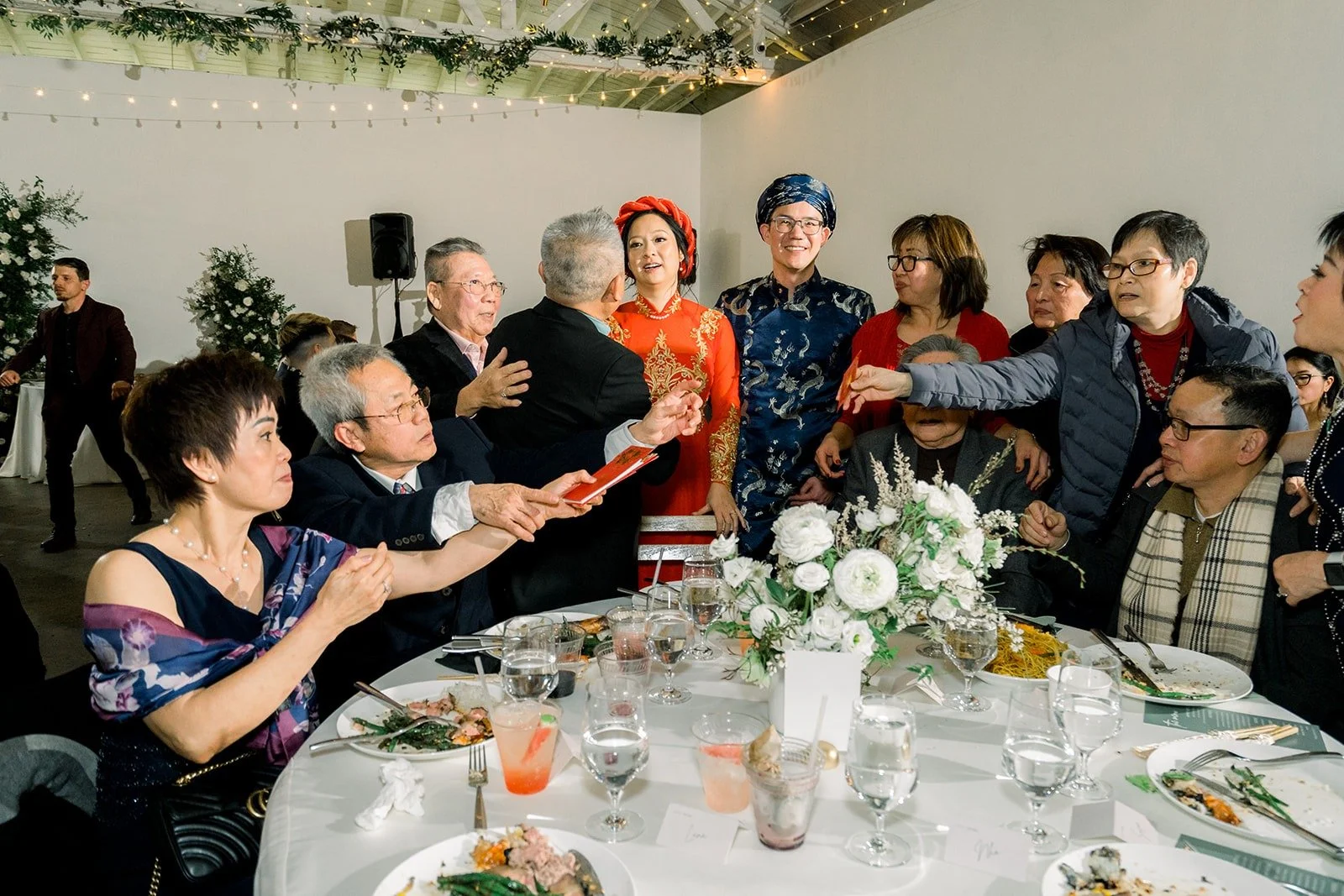 Cindy and Alex make a table toast with guests