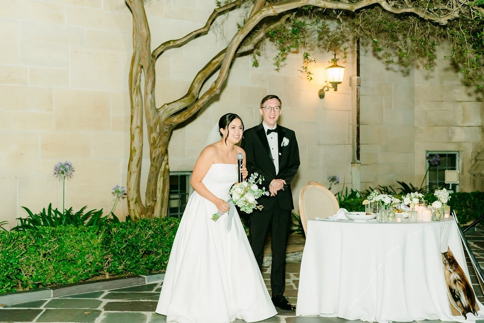 Wide view of the cake cutting in the courtyard