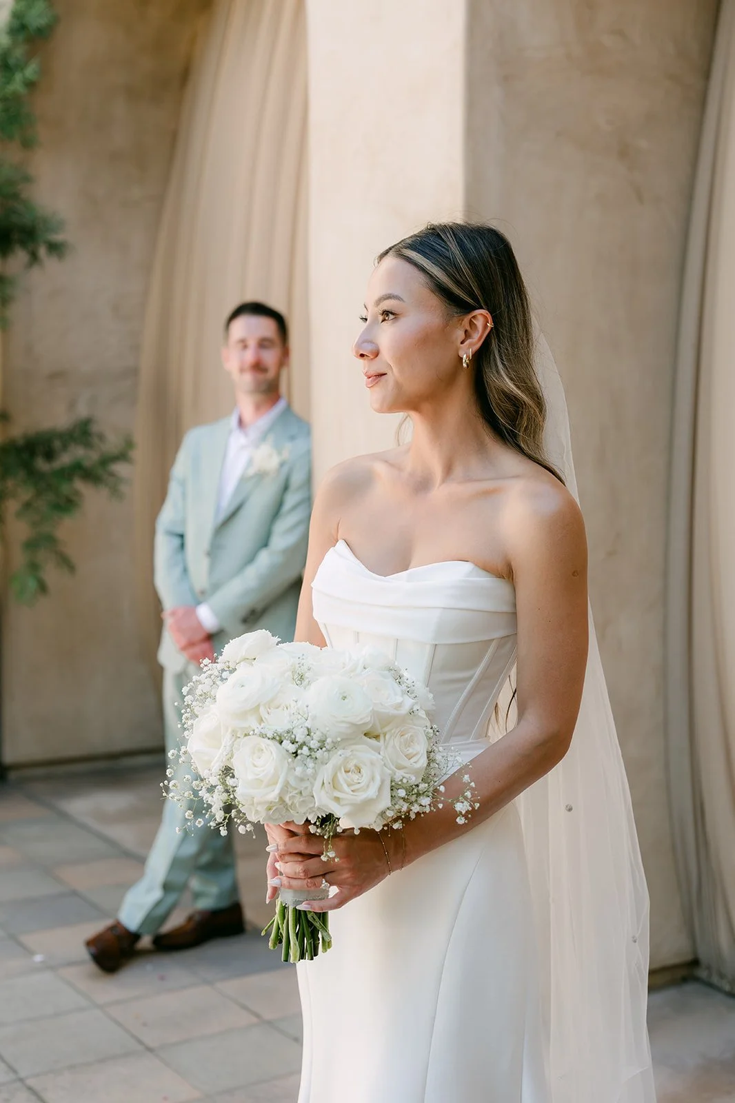 Groom watching the bride as she looks off to the side