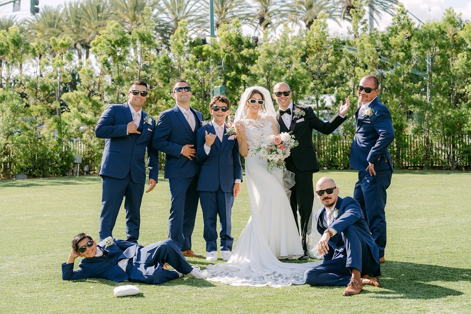 The groomsmen strike playful poses around Francesca and Daniel, photographed by One and Only Production