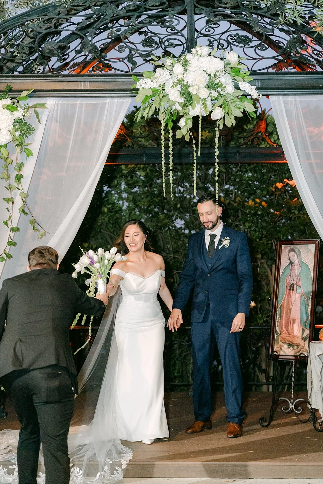 Mariana and Danny as husband and wife beneath the gazebo