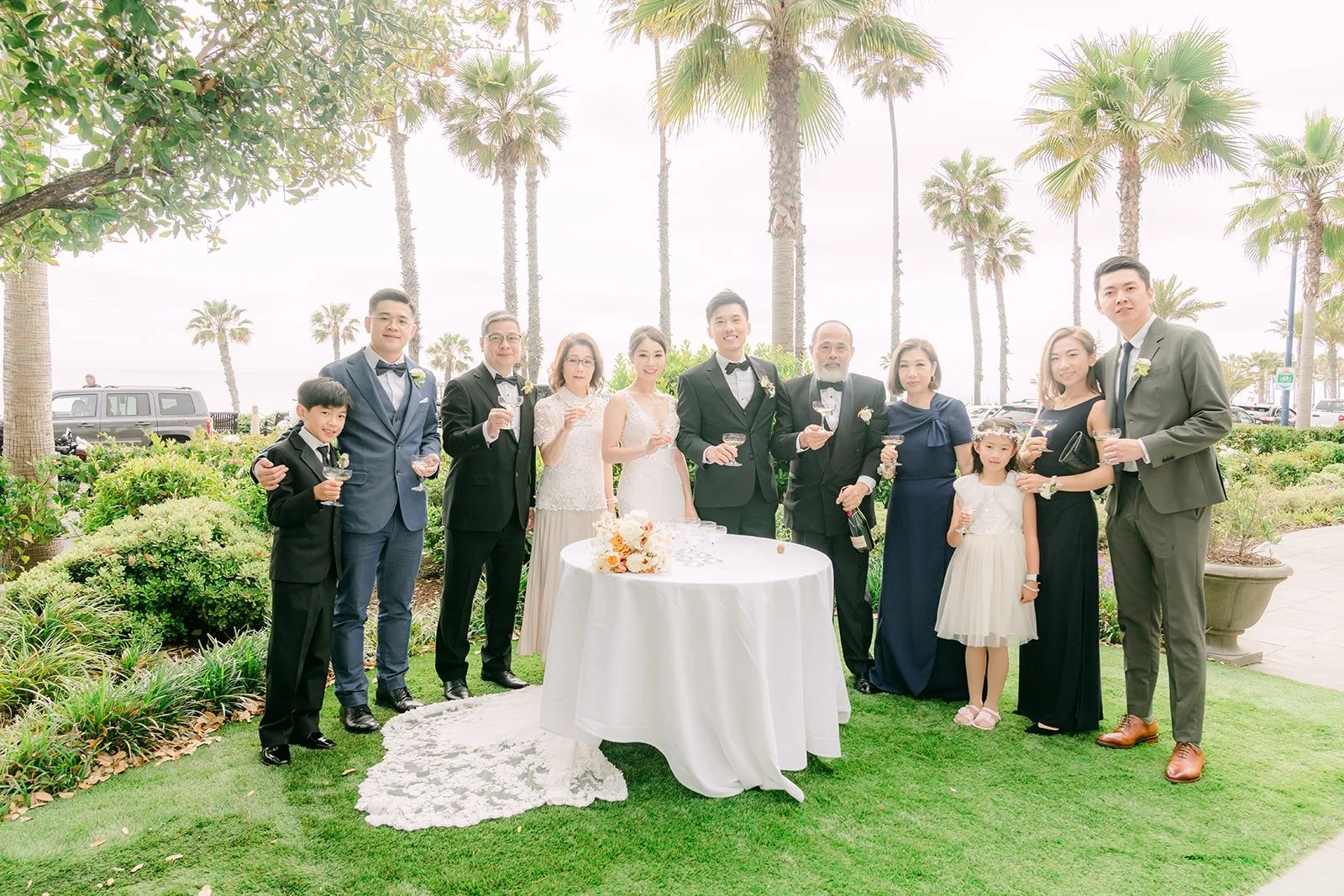 Family members gathered around the champagne tower on the lawn