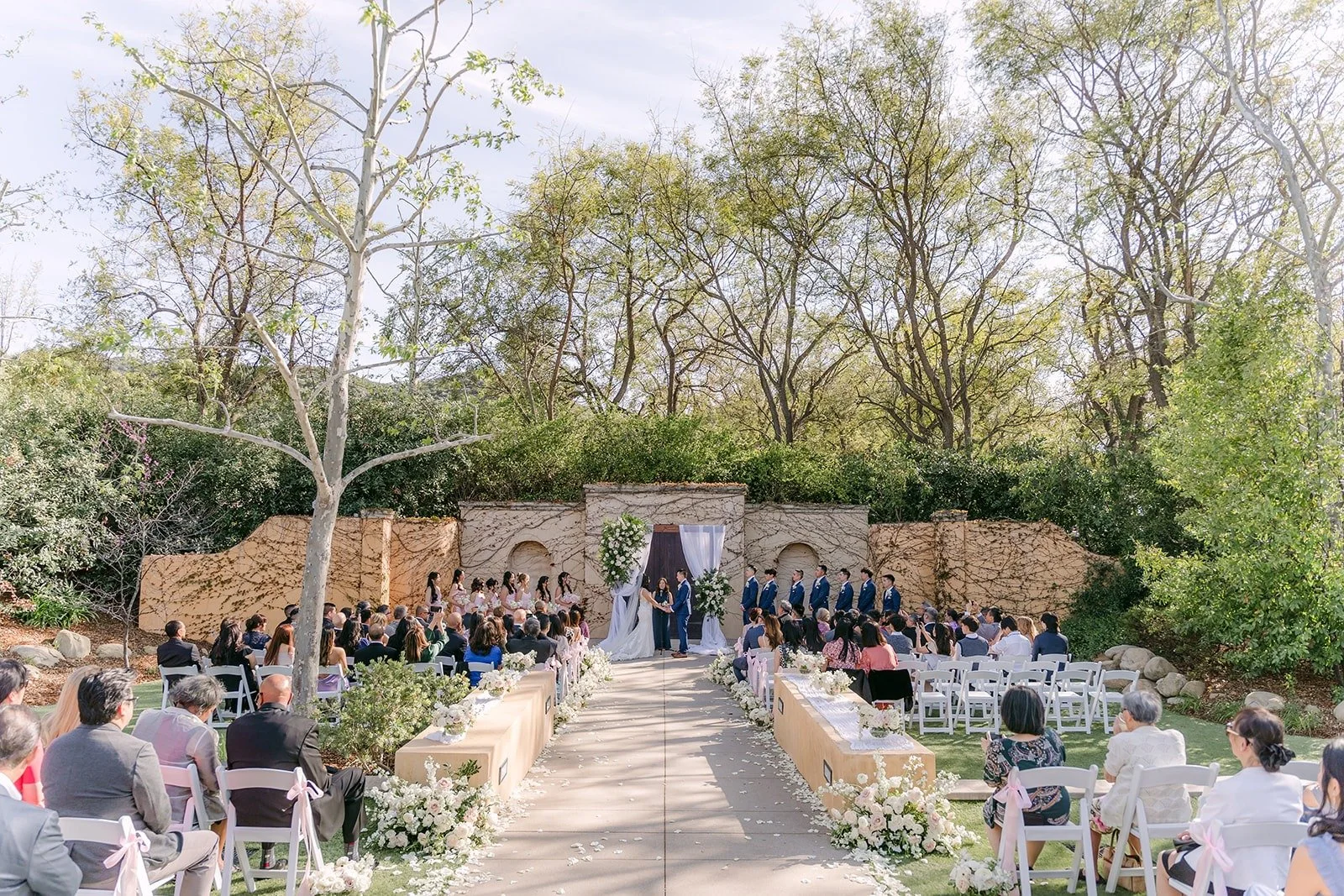 A wide view of guests seated for the outdoor ceremony at Los Robles Greens
