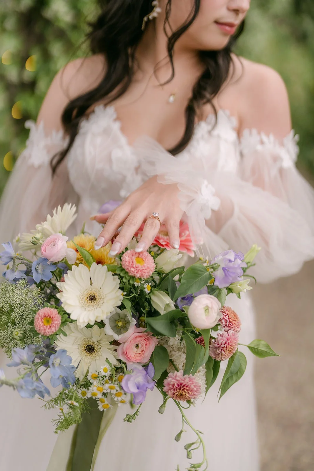 Kat's pastel bouquet of dahlias, daisies and roses with her engagement ring