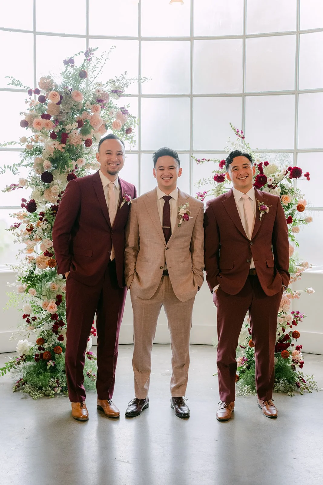 Michael with his twin brother Kevin and older brother Robert between the floral columns.