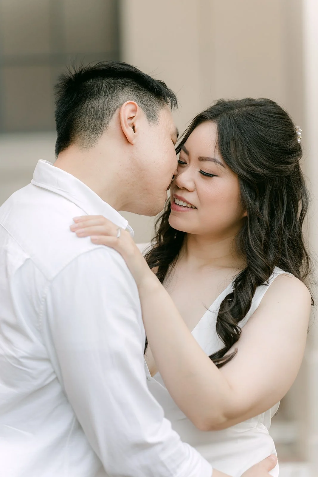 Close-up of James kissing Emily on the cheek.