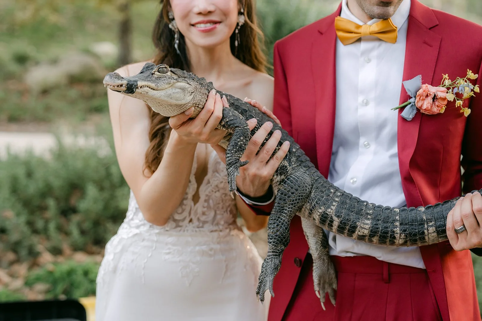 Christie and Christian holding the mini alligator together.