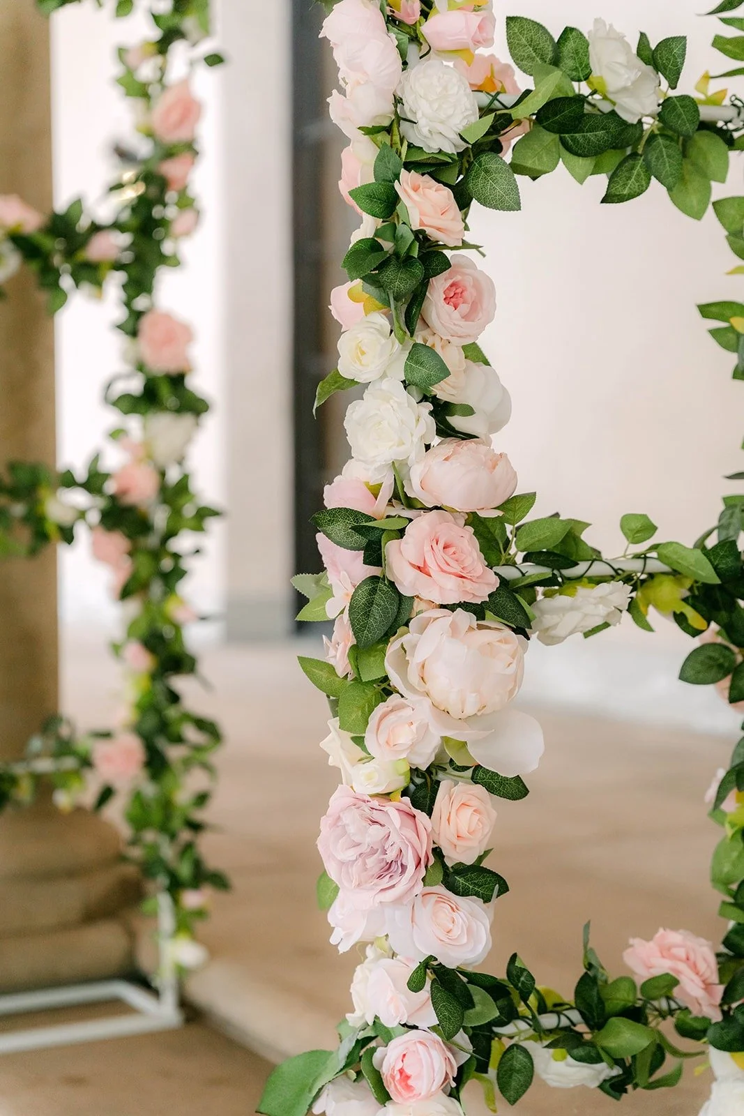A close look at the blush and white rose arch for the ceremony