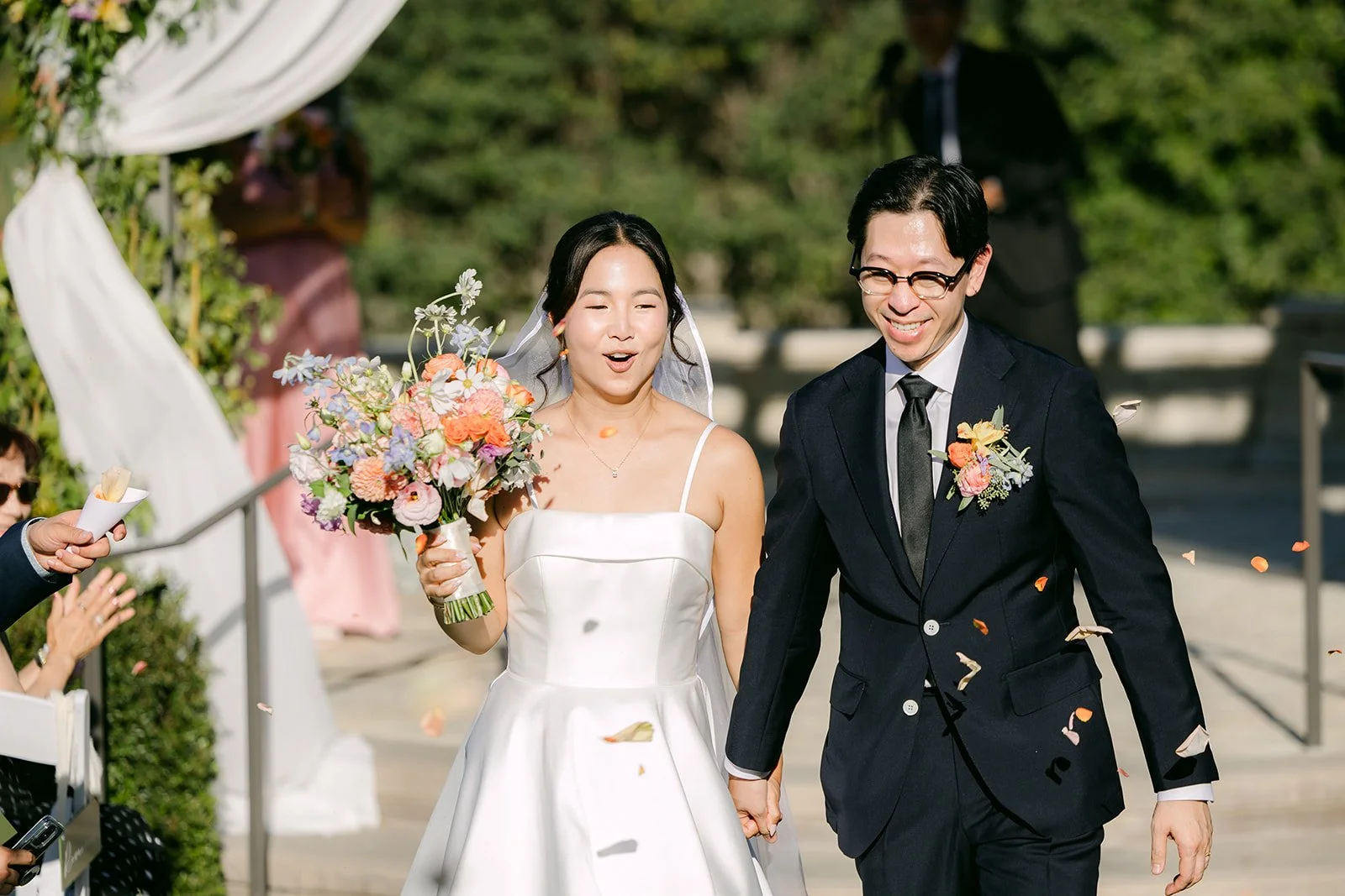 Saya and Leroy walking back up the aisle as newlyweds