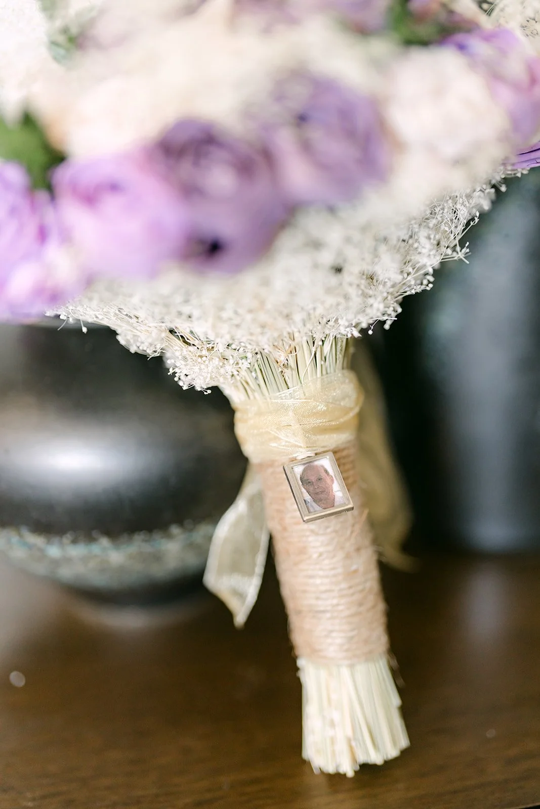 Close-up of Mai's lavender and white bouquet with a lace wrap.