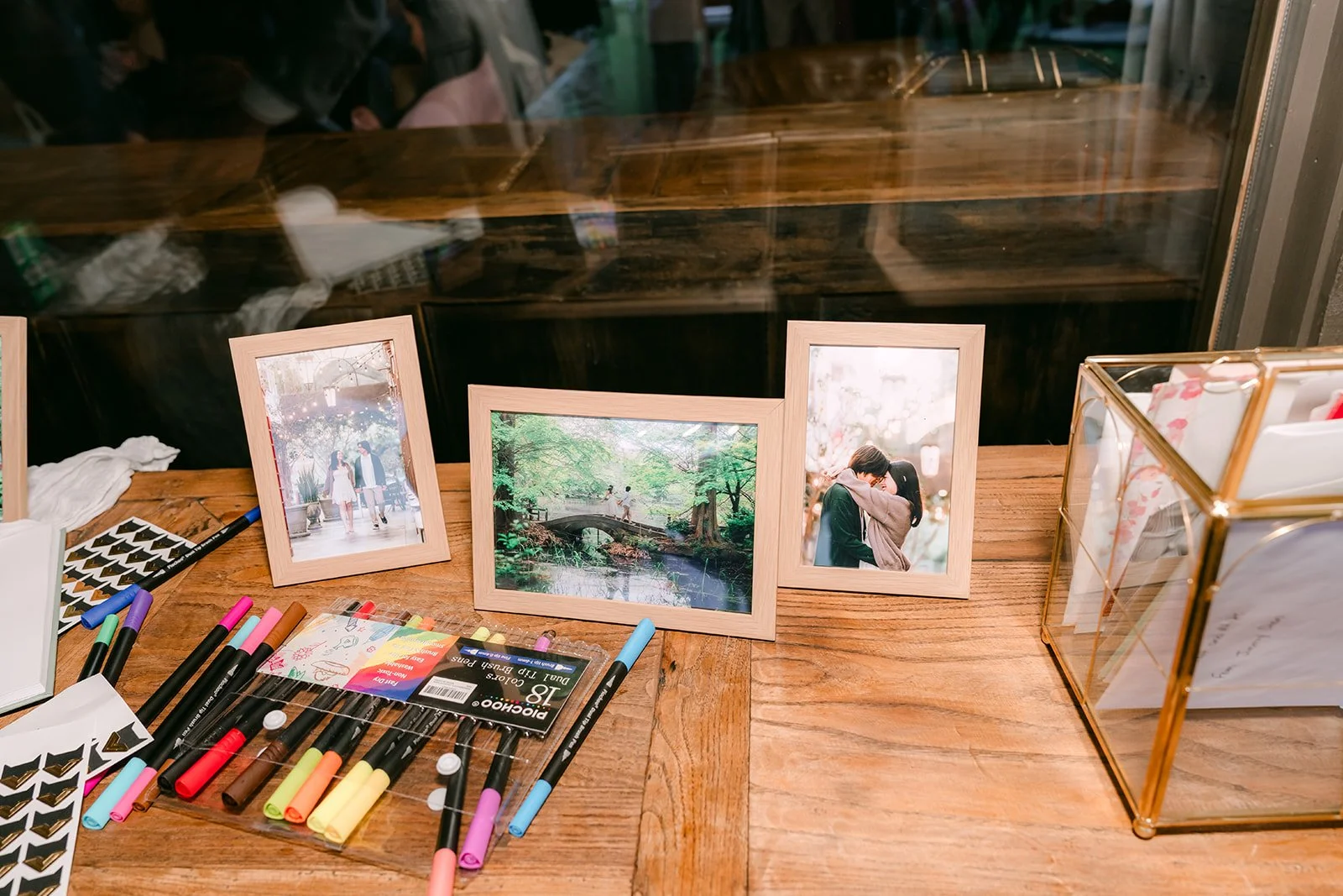 Guest book table with framed couple photos and markers