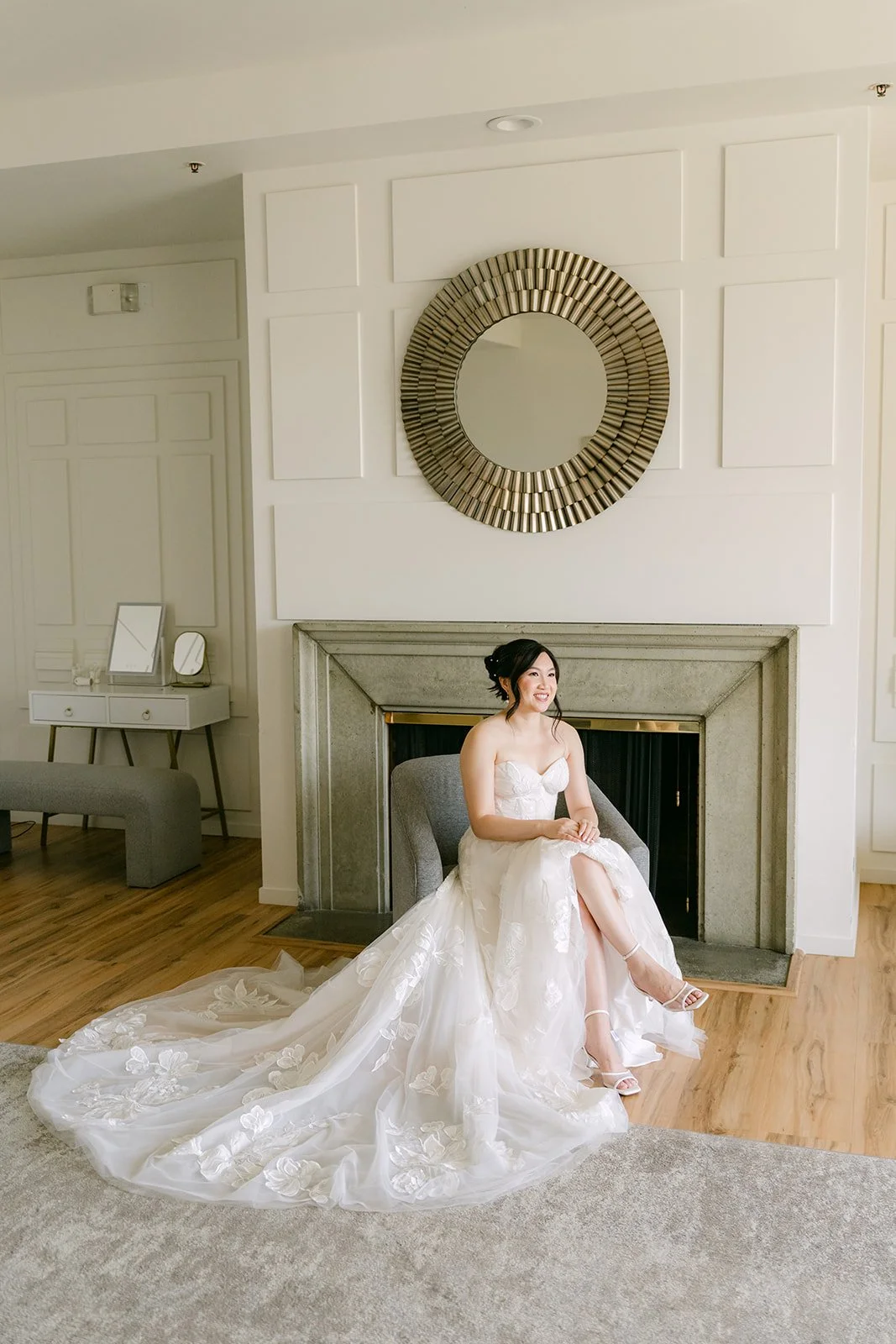 Mary seated by the fireplace in her gown