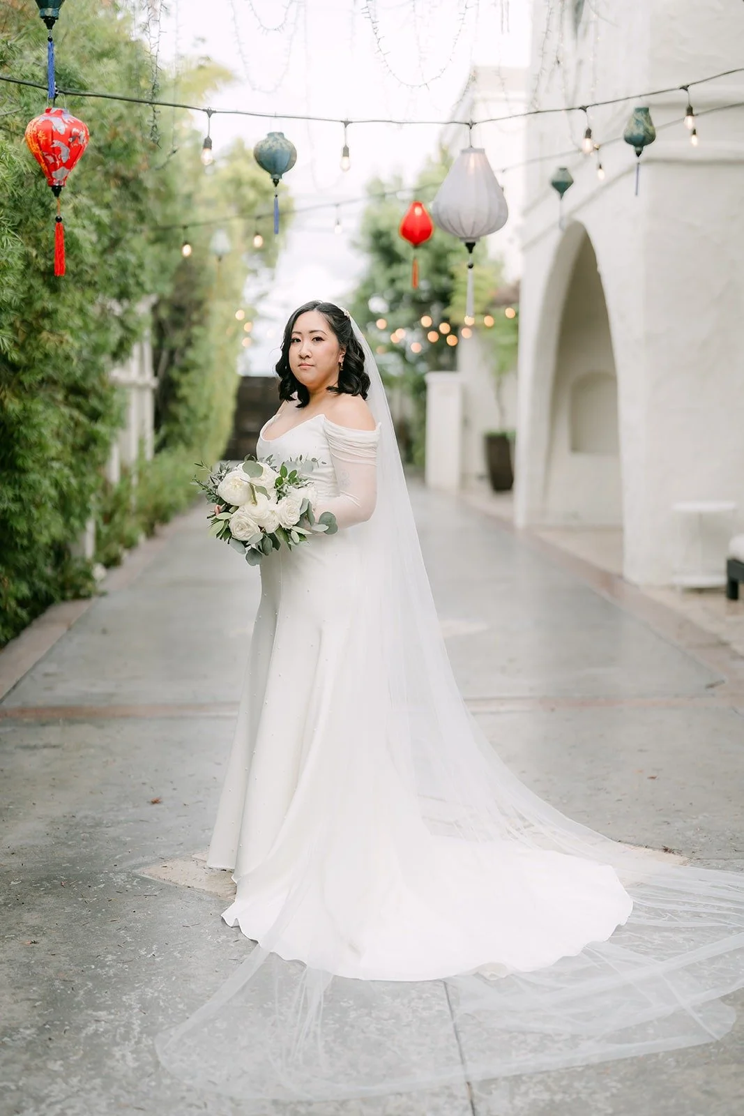 Vivian in her off the shoulder gown in the courtyard at The Villa