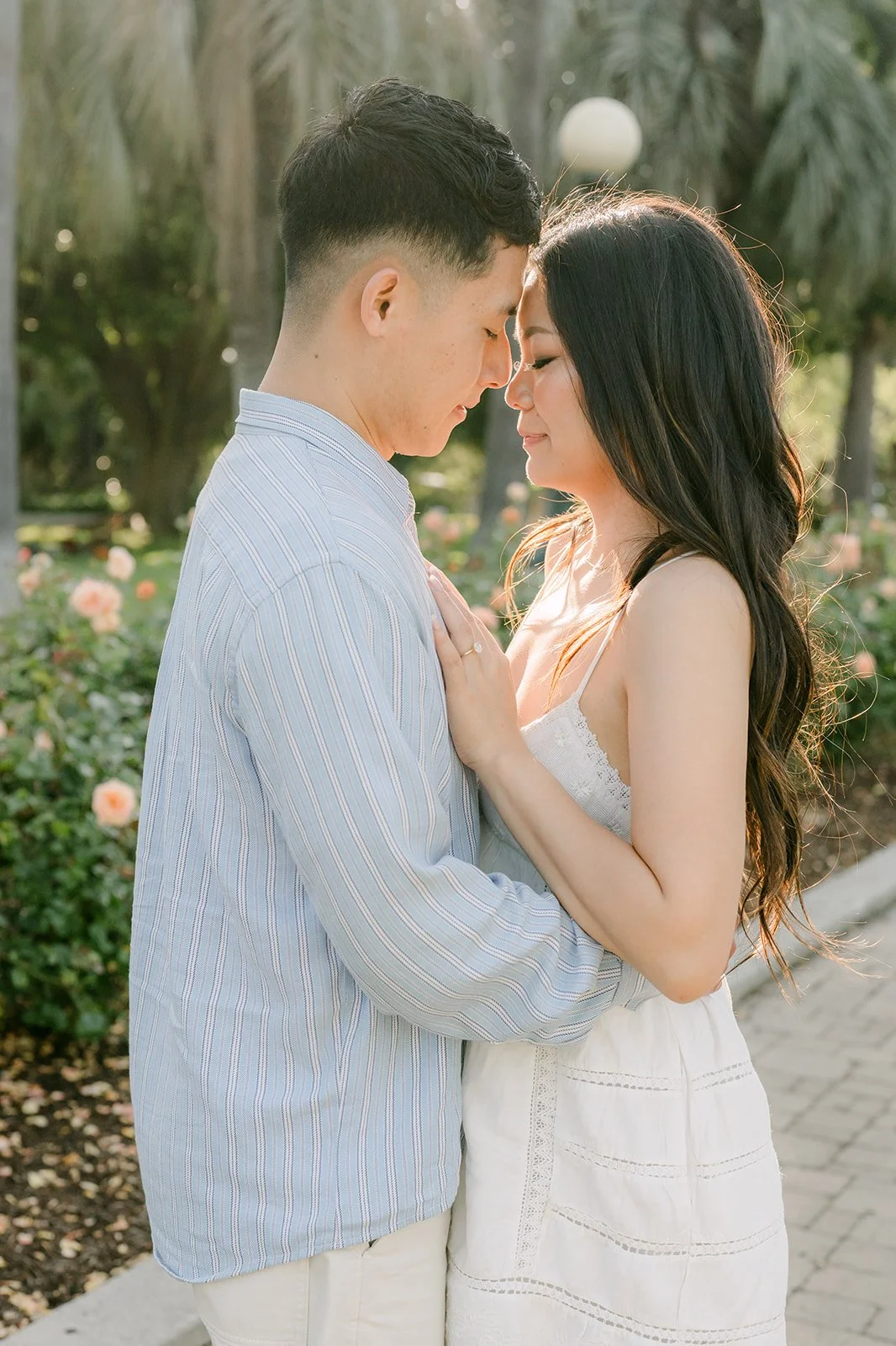 Jadee and Richard touch foreheads in the park.