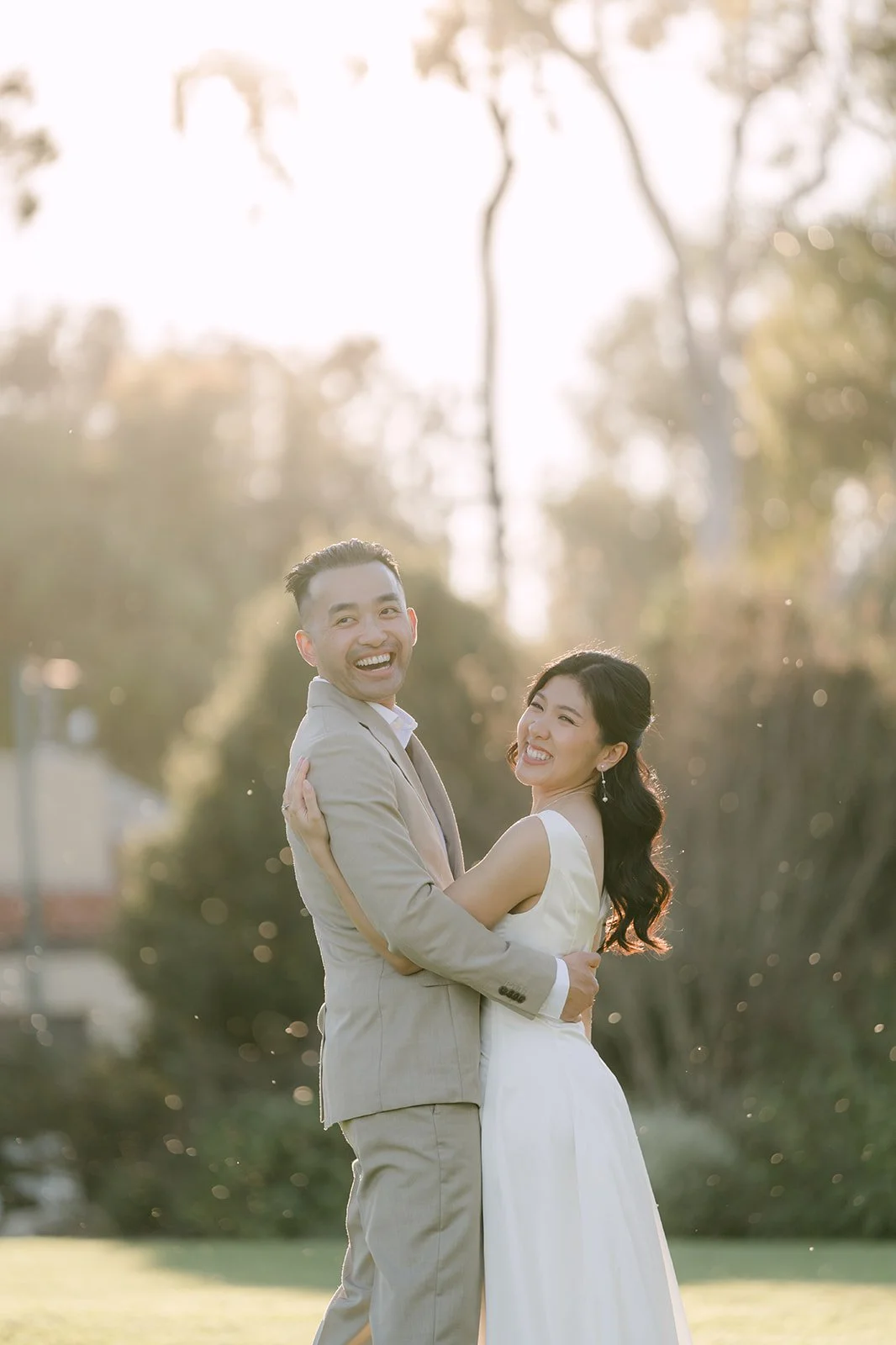 Kim and Vincent in a close embrace at golden hour.