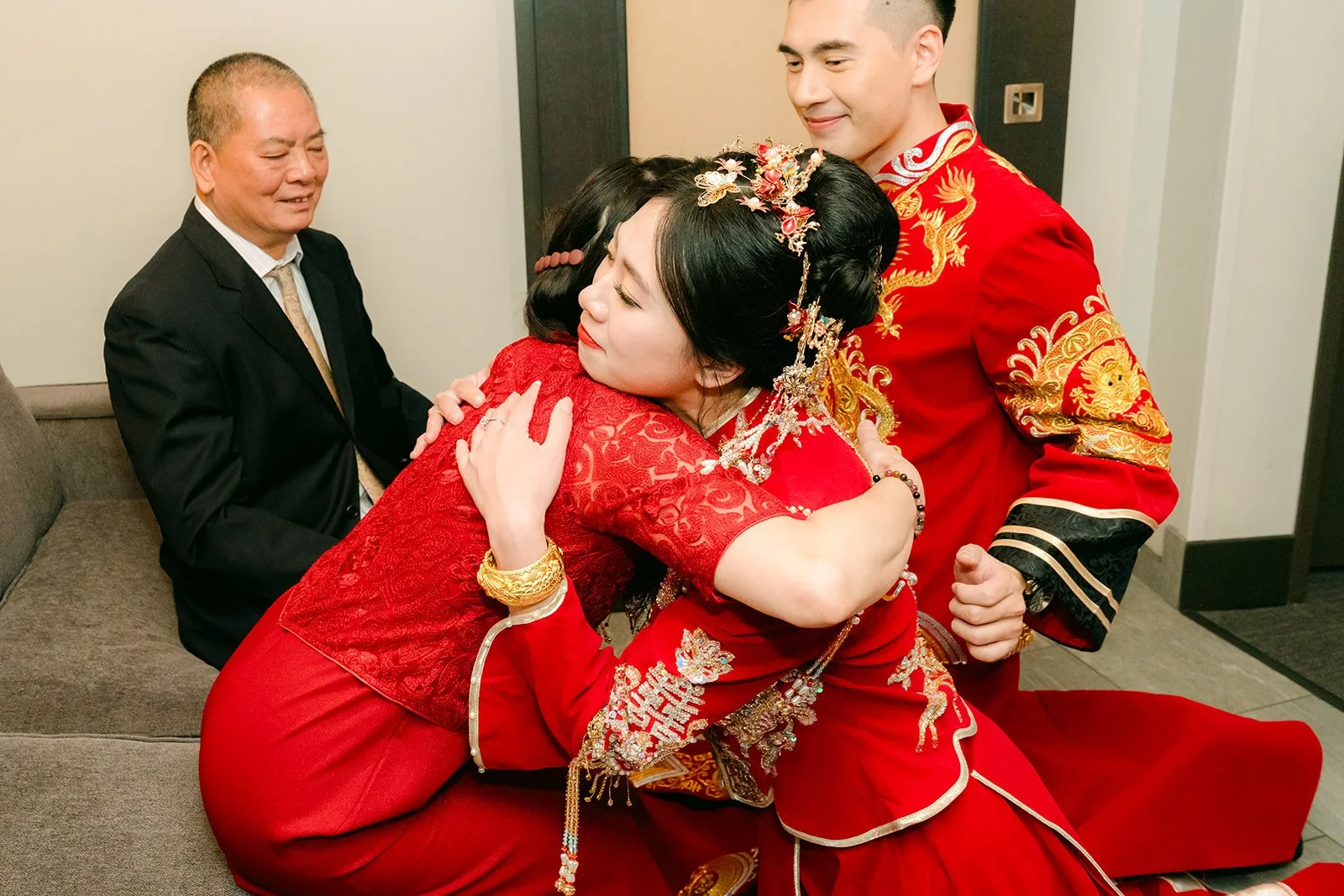 A bride hugging her parent after serving tea.