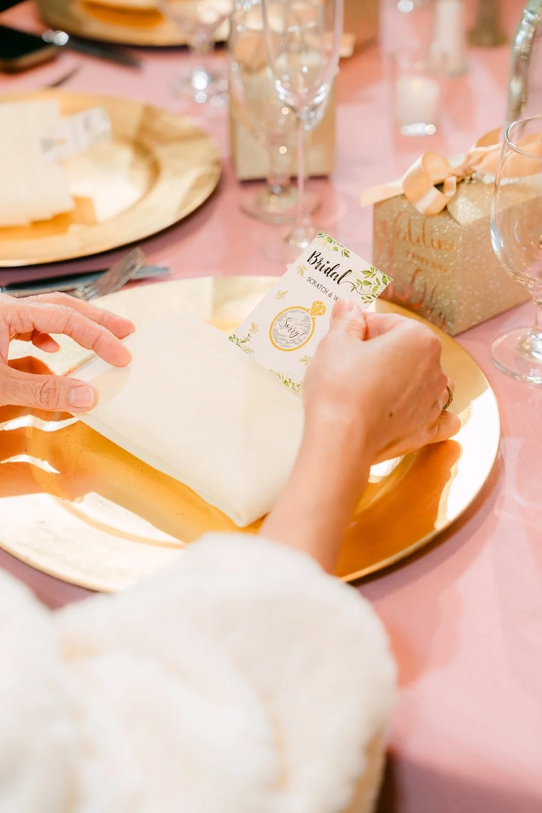 A guest opening a party favor at the reception
