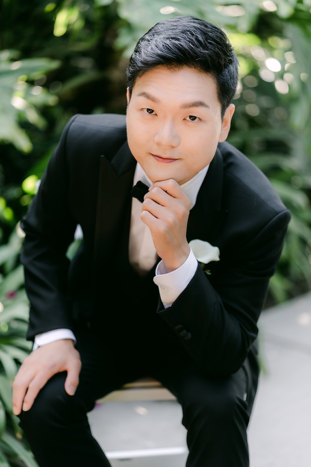 Eunsang sitting for a portrait with his hand at his chin