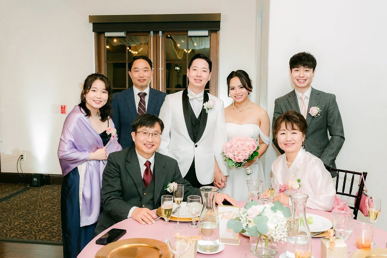 Ivy and Chungman with friends at a table