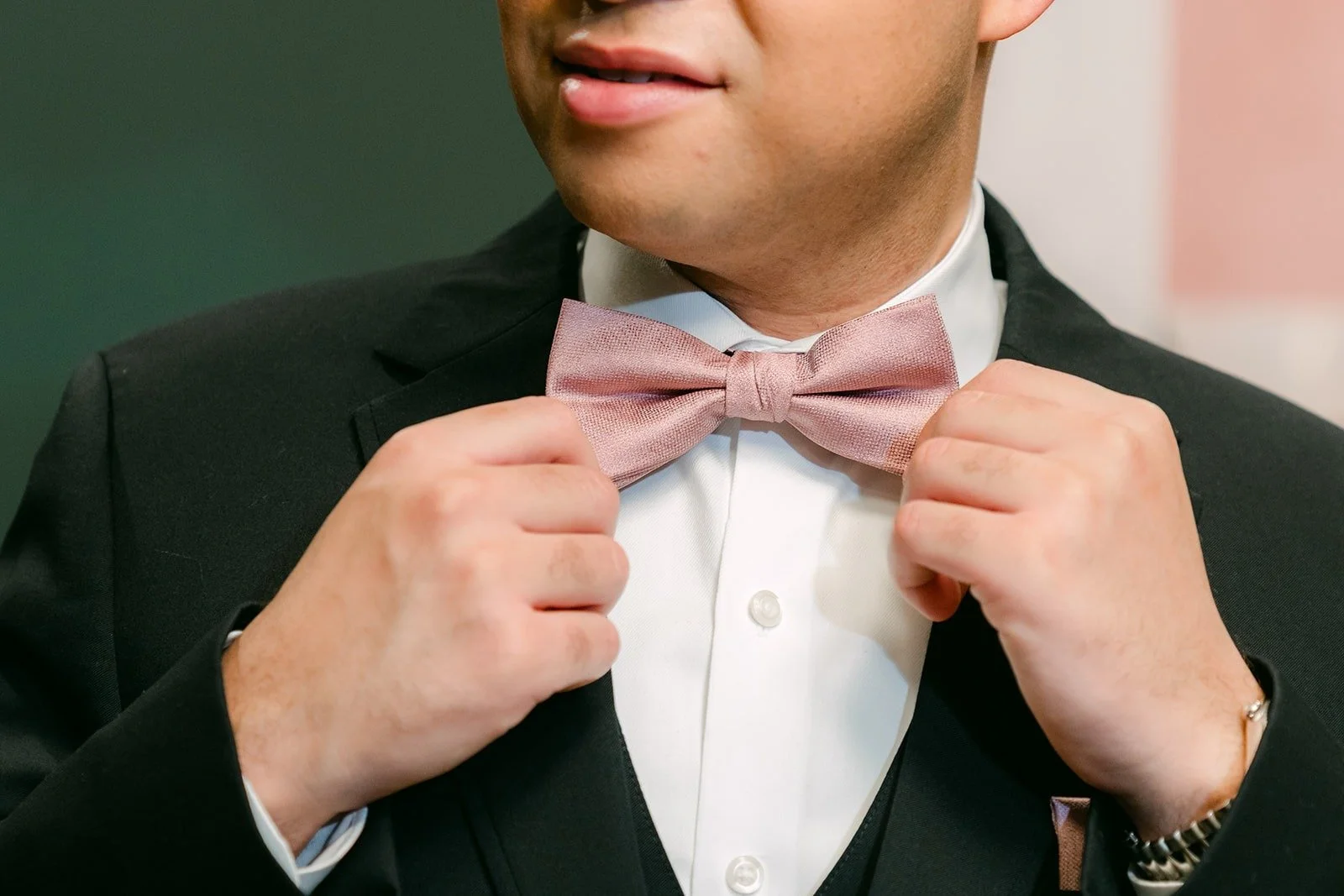Brandon straightening his pink bow tie at The Headquarters in San Diego