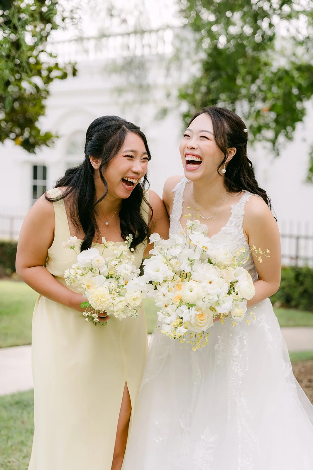 Jenny laughing with her best friend as they hold their bouquets.