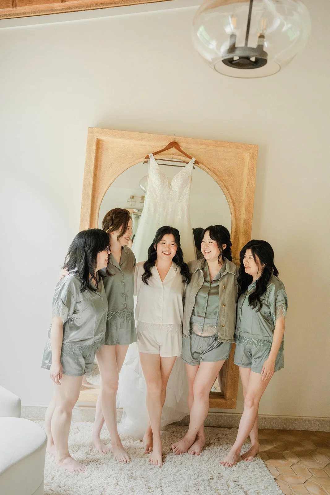 Bride with her bridesmaids in matching satin pajamas