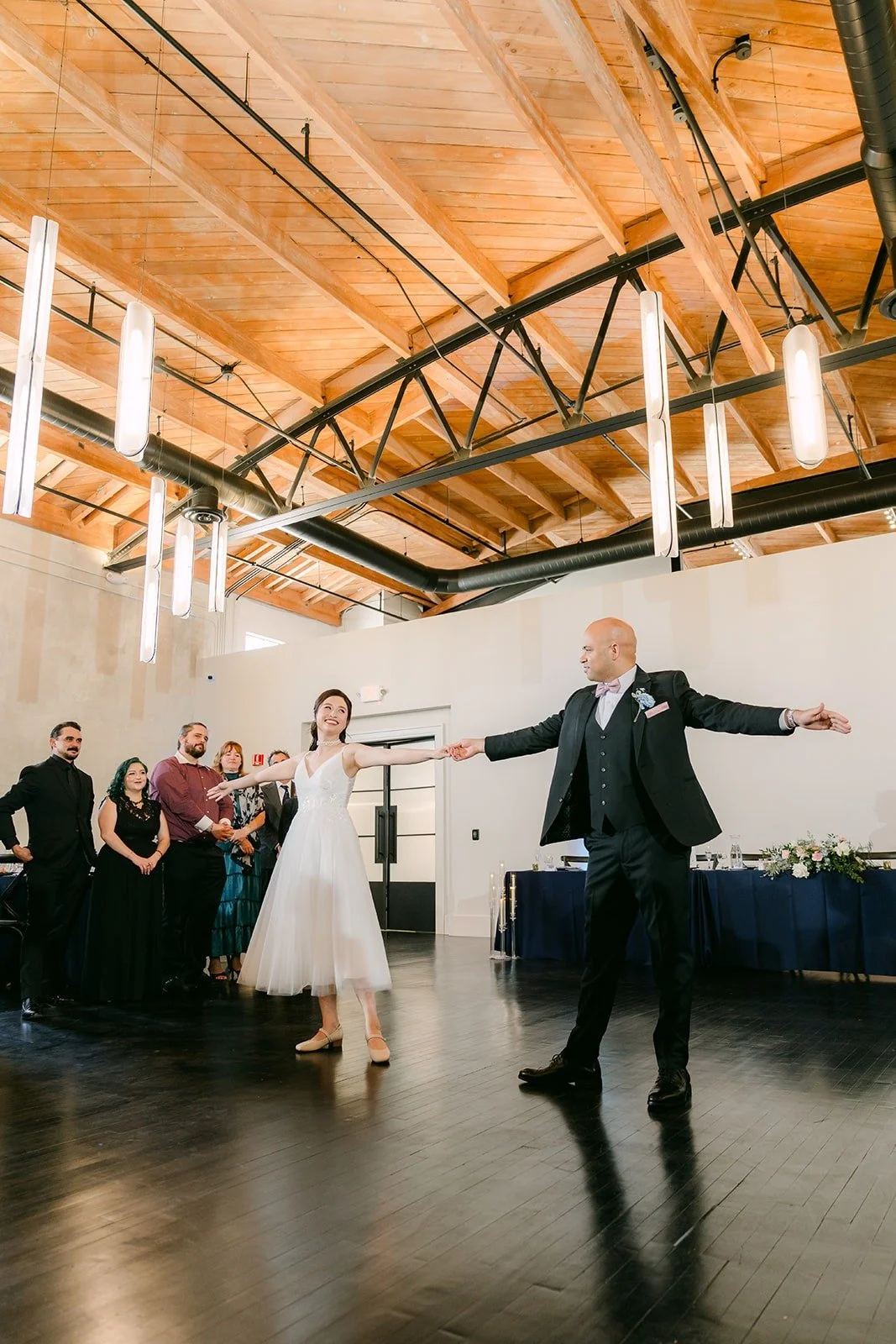 Brandon opens his arms wide during the first dance