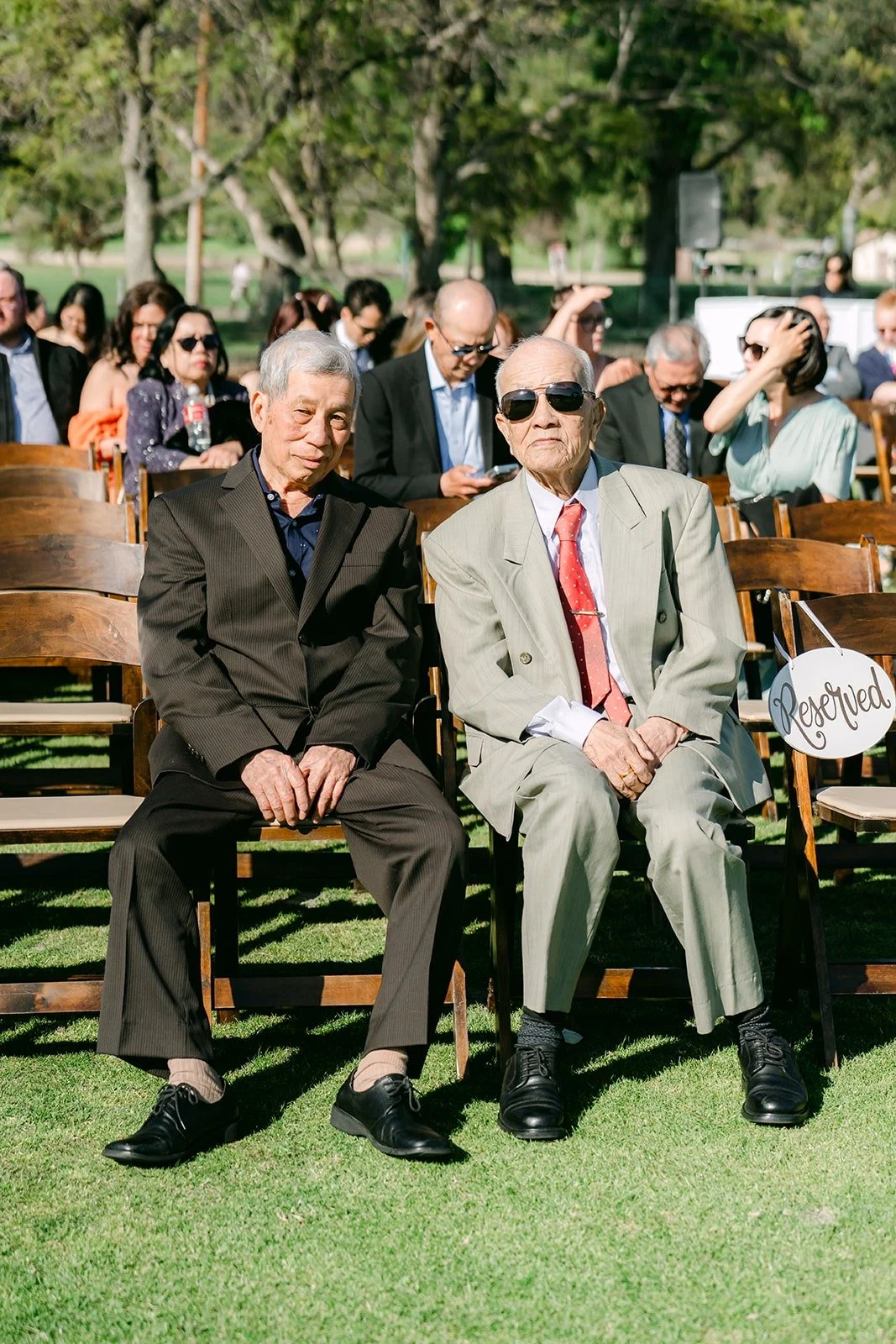 Two guests seated in the front row before the ceremony