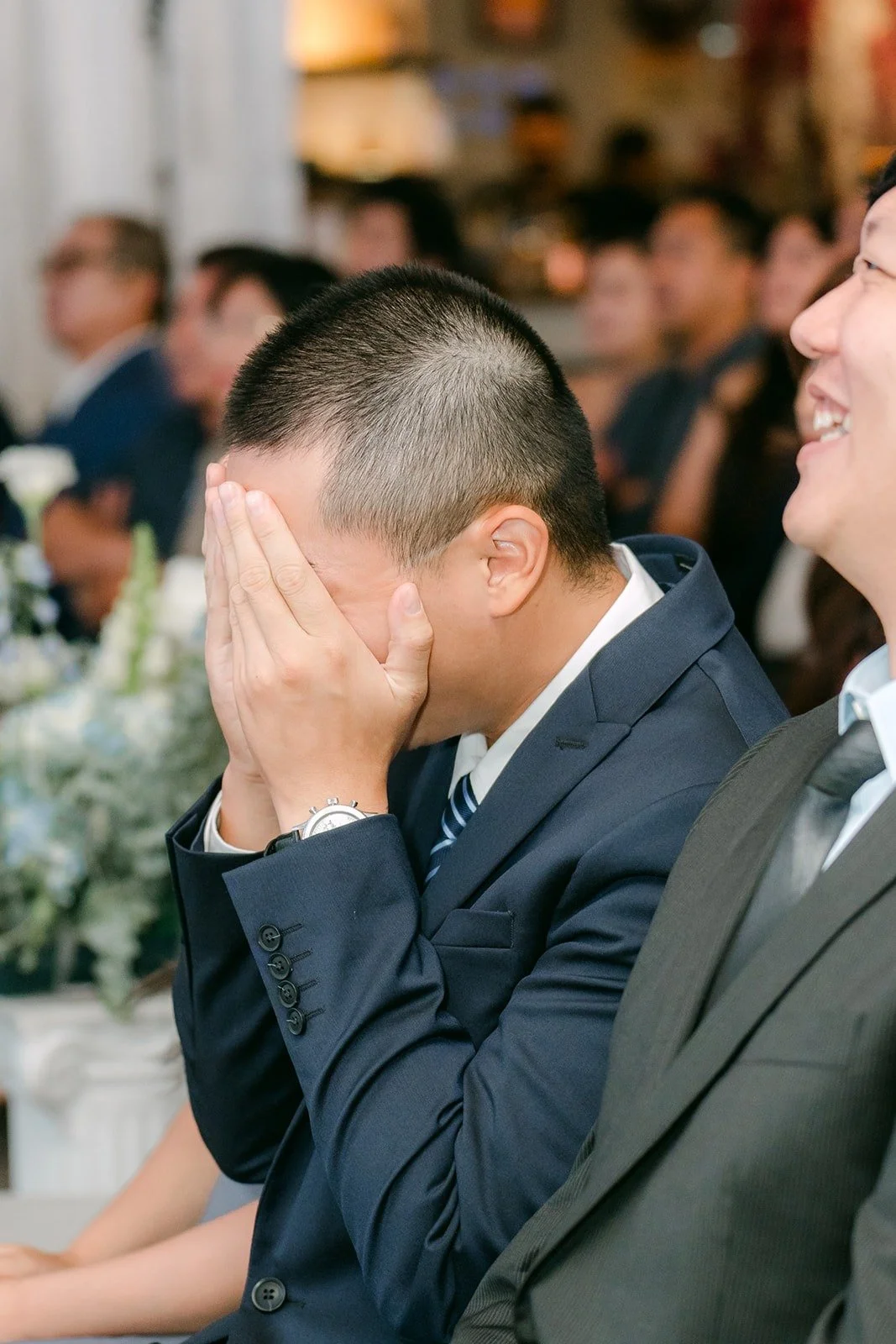 A guest wiping away tears during the ceremony