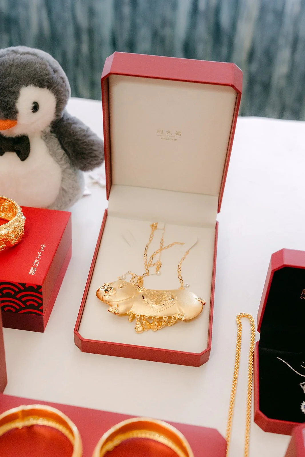 Gold jewelry gifts waiting in red velvet boxes before the tea ceremony.