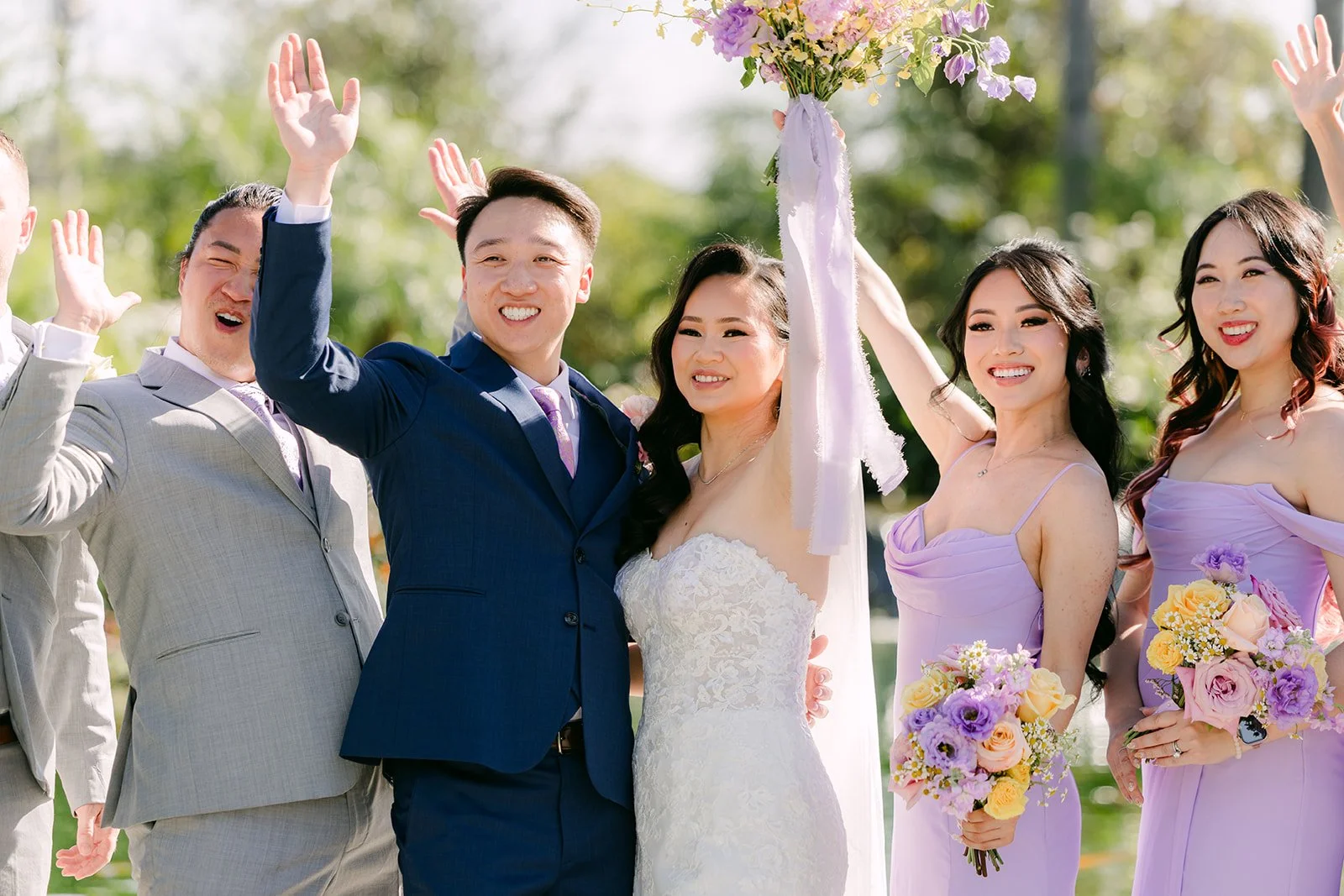 The wedding party cheering around Vannie and Elijah.