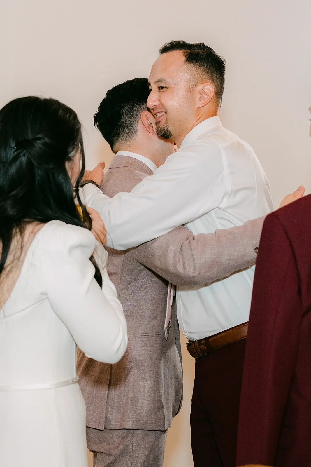 Michael hugging a guest during table visits.