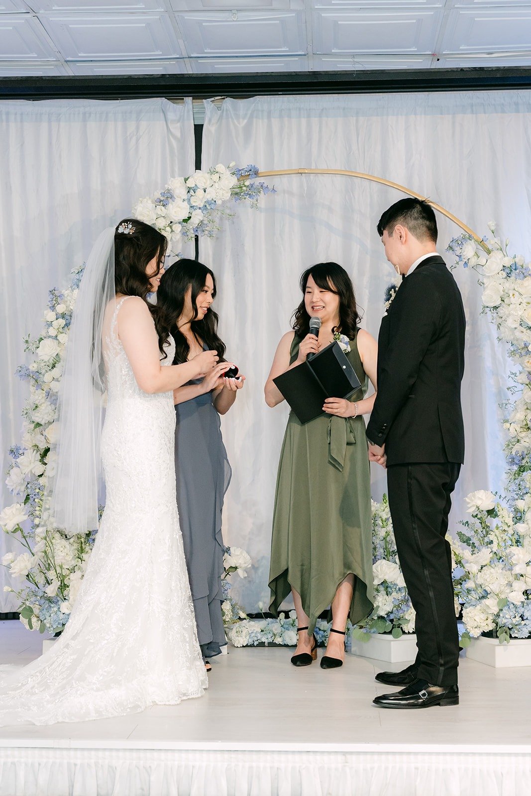 Emily and James holding hands under the crescent arch
