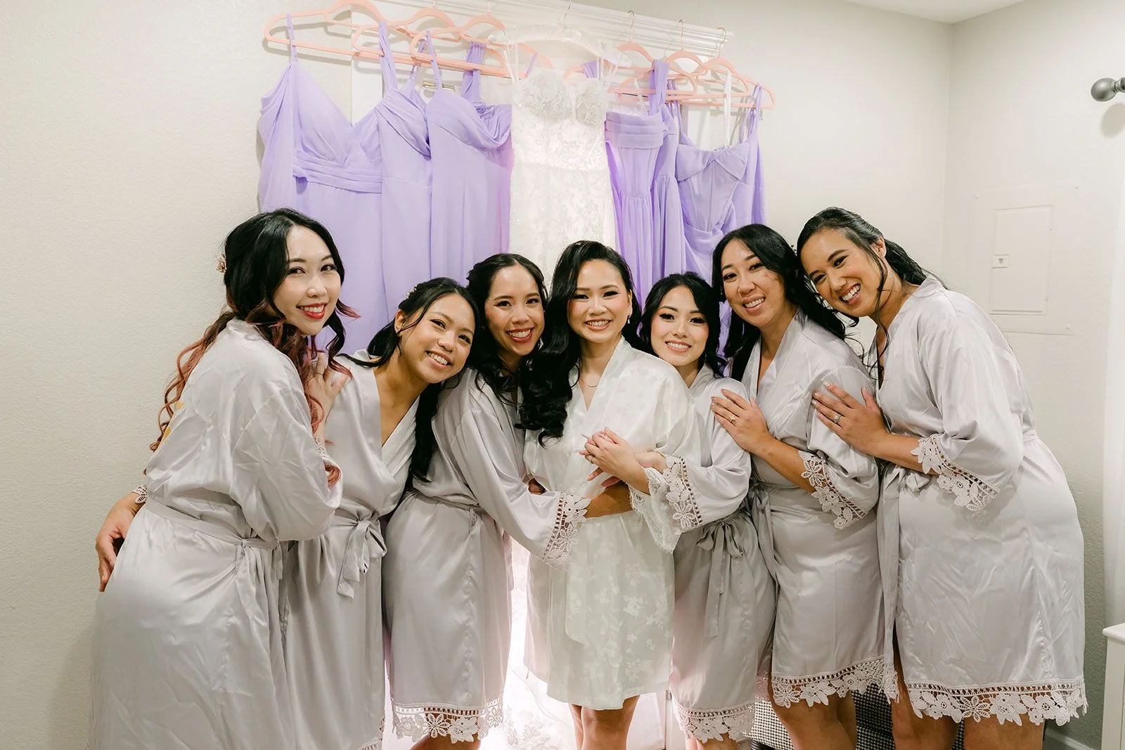 Vannie and her bridesmaids laughing in matching robes.