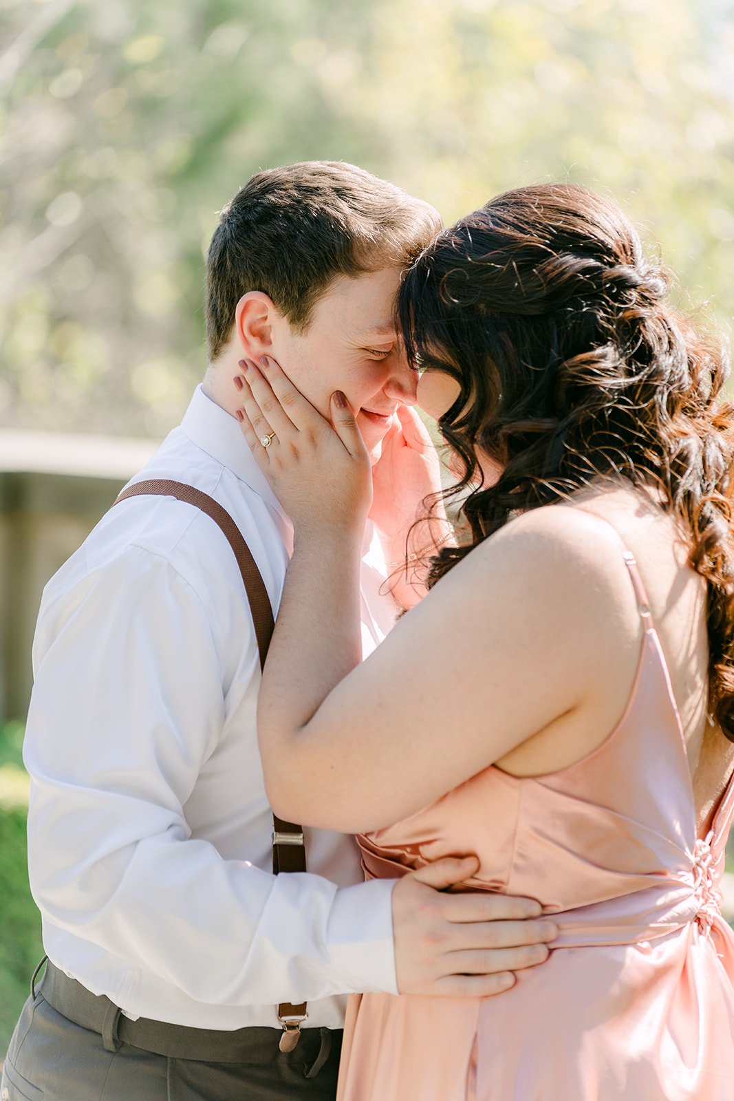 Saira cradles Matthew's face as they lean in close.
