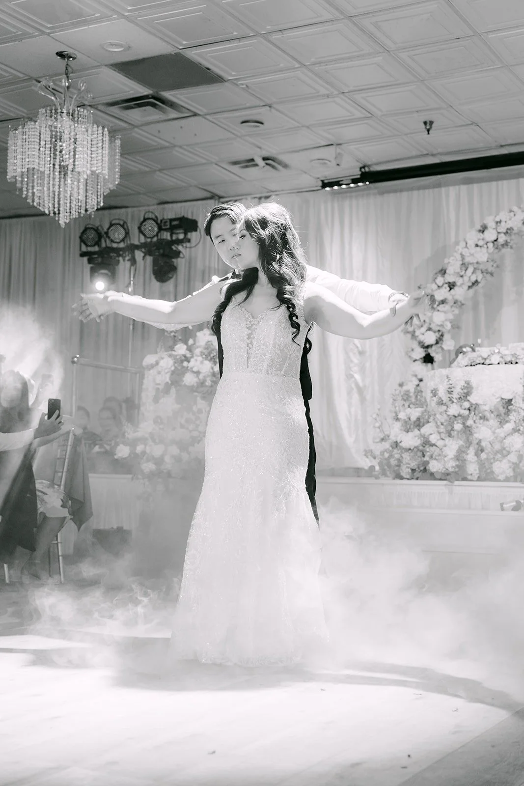 Black and white of Emily twirling in the fog