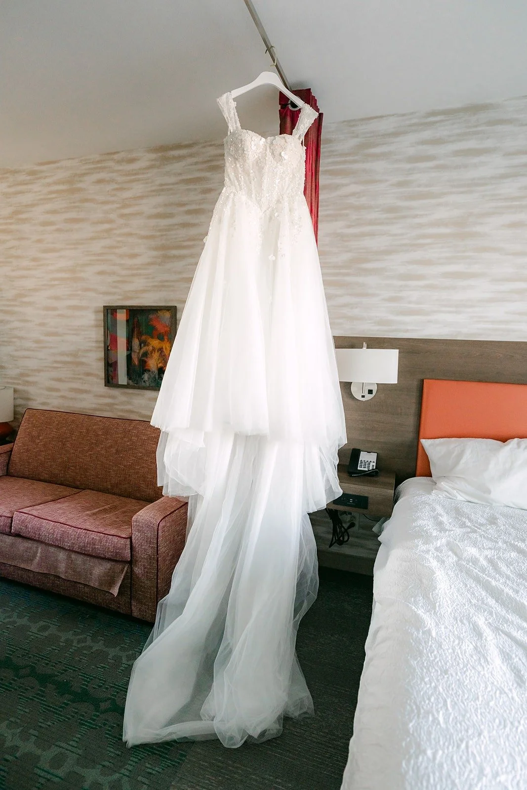 Jennifer's wedding gown hangs in the suite at Home2 Suites by Hilton Garden Grove