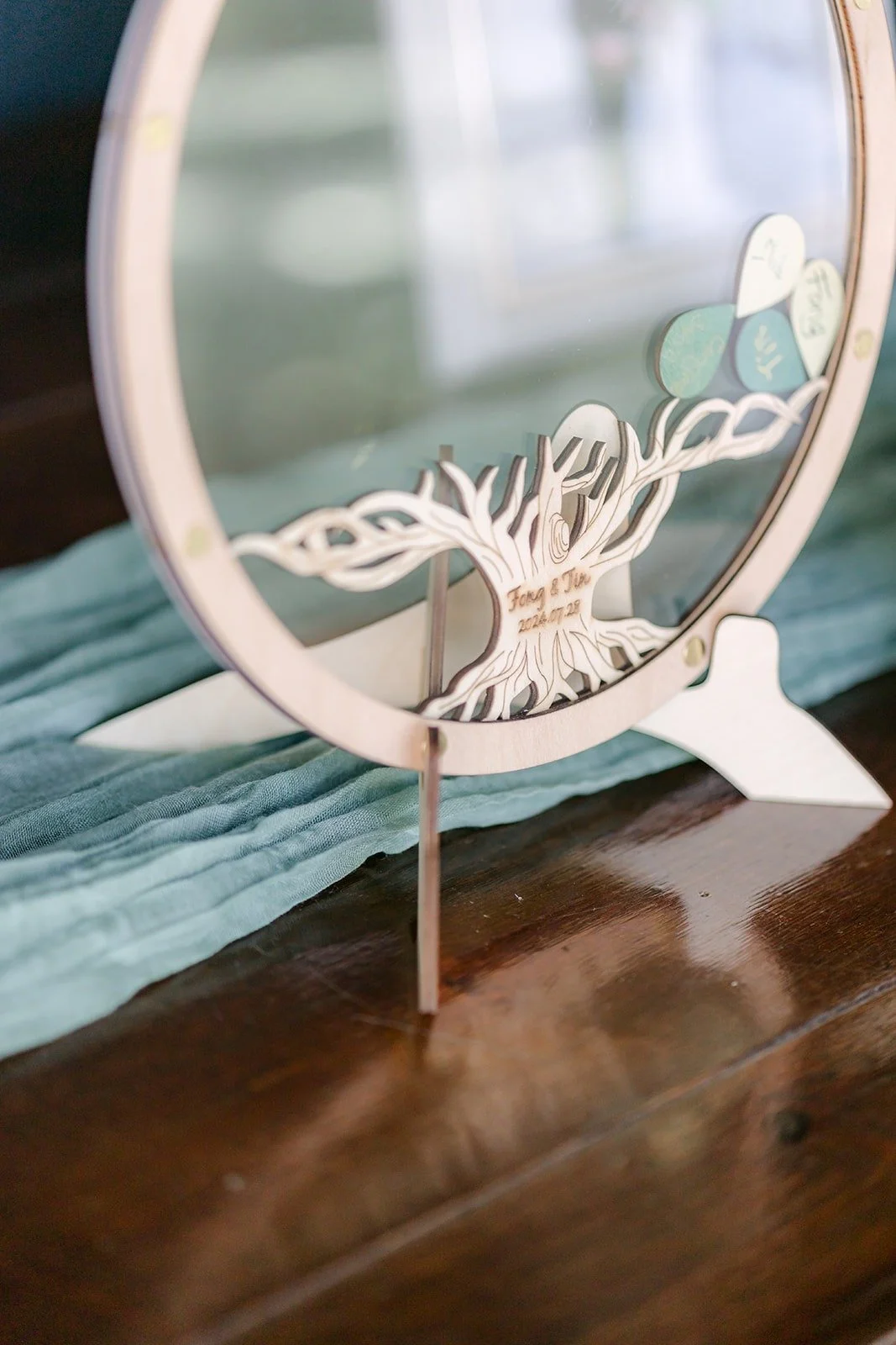 A floral hoop sign at the ceremony entrance