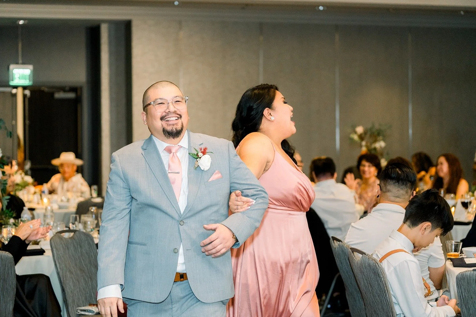 A wedding party pair dances in during the grand entrance